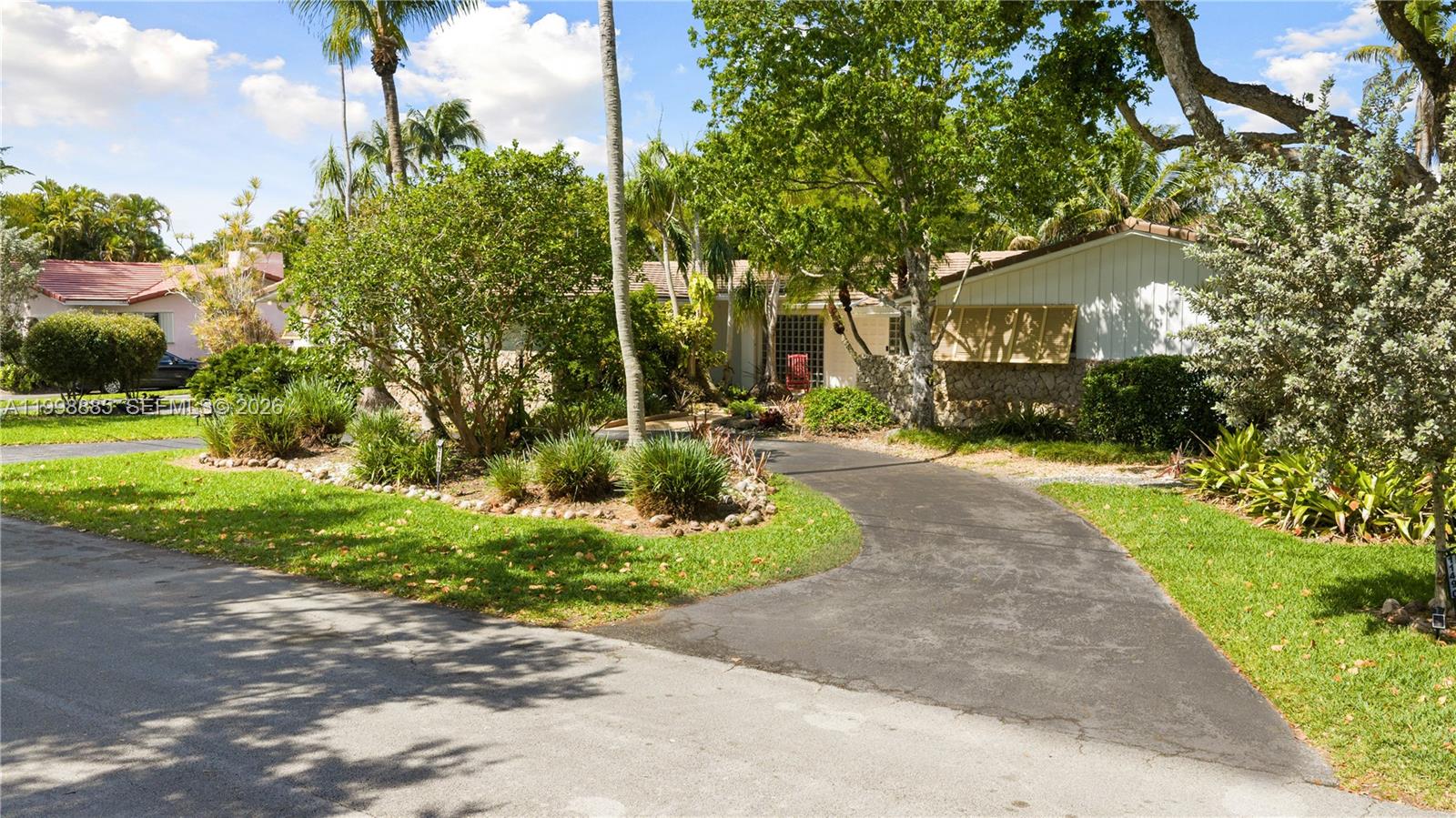 Tucked away on a quiet street in Pinecrest, this 4-bedroom, 2.5-bath canal-front residence offers a flexible layout and serene surroundings. Originally built by Hollub, the home reflects solid construction and thoughtful design throughout. Upon entry, a unique tropical art carved glass feature sets a distinctive tone, adding character and visual interest.  A spacious living room overlooks a private enclosed atrium with a calming water feature, bringing in natural light and an indoor-outdoor ambiance. Family room features vaulted tongue-and-groove ceilings, creating an open and airy atmosphere.

The kitchen is appointed with quartz countertops, updated cabinetry, and ample storage. Additional storage is found throughout the home, supporting everyday functionality. All windows and doors are impact-rated for safety, energy efficiency, and peace of mind. A full-house generator provides uninterrupted power and added convenience.

Outdoors, the fully fenced yard is divided into three separate sections, offering versatile space for entertaining, pets, play, or gardening. The pool features a sun shelf for lounging and is enclosed within a screen for year-round enjoyment. The canal-front setting adds privacy and a tranquil backdrop.

Desirable Pinecrest location close to schools, shopping, dining, and community amenities. A unique opportunity to enjoy quality construction, flexible living spaces, and a peaceful setting in one of the area’s most sought-after neighborhoods.