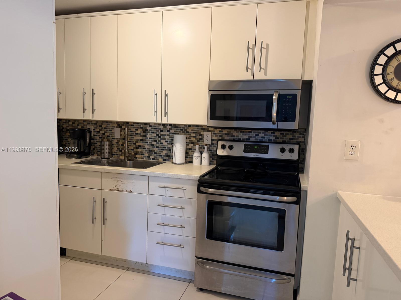 BEST DEAL! Completely remodeled first-floor apartment featuring elegant porcelain tile throughout and a magnificent lake view from the entire unit. This bright and inviting residence offers abundant natural light and a functional layout, ideal for both end-users and investors. Upgrades include a new A/C, new washer, and electric water heater. Located in a gated community with easy access and convenience of ground-floor living. Excellent opportunity as a primary residence or income-producing property. Easy to show!