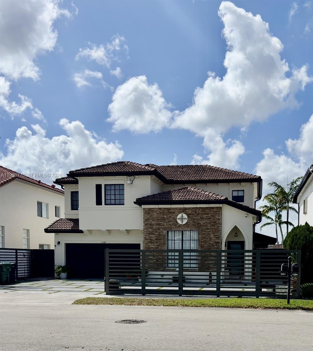 Modern elegance meets exceptional functionality in this immaculate home! This two-story gem offers 5 bedrooms and 3 bathrooms, plus a half bath, with one bedroom and a full bath downstairs, with access to the outdoors. Enjoy a formal living room, family room, and spacious kitchen, open to a backyard oasis with a heated pool & hot tub and terrace. Home features a large fenced entrance ideal for an RV or boat, all windows and doors have blinds, built-in California closets in every room, and ample parking on the property. Both chandeliers in the living/dining area convey. Located next to A-rated charter schools, transportation, Restaurants and Supermarkets, this home seamlessly blends modern design, luxury upgrades, and effortless indoor-outdoor living in a prime Miami location.
