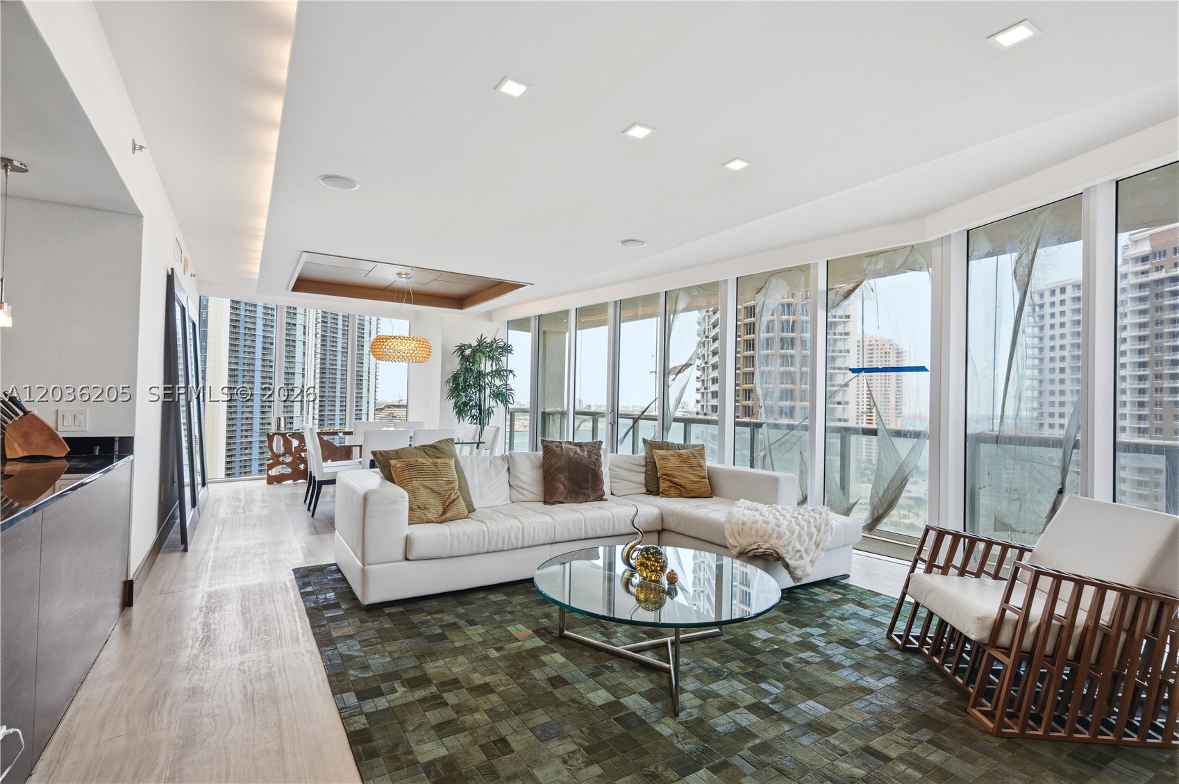 ATTENTION: Offering seller’s financing with below market rates for qualified buyers. Introducing the most desired corner 3-bedroom line in Icon Brickell - North Tower, enjoy picturesque vistas every day where the miami river meets Biscayne Bay and the ocean most dream of, showcasing a rare original developer build-out executed with the highest quality materials. Sun-filled living areas feature imported Israeli marble floors, while all bedrooms offer warm hardwood flooring. Rich wood paneling throughout, soffit ceiling with LED ambiance lighting, a ceiling-embedded sound system, electric shades create a refined, turnkey experience plus exquisite, custom lizard-skin closets with suede backing and additional bespoke upgrades throughout. Offered with fully furnished with Artefacto furnishings. A true collector-quality residence in one of Brickell’s most iconic waterfront towers. Icon Brickell offers truly luxury amenities, expansive fitness center, hotel grade spa, meeting rooms, theater, and more.