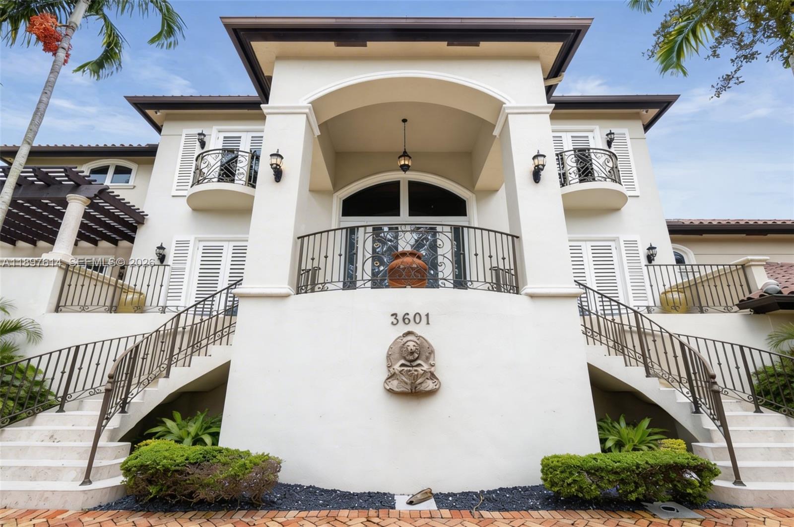 Situated within 24/7 guard-gated Entrada Estates, this Grove estate balances scale, function, and flexibility. Total area around 14,000 SF of A/C living space, including a rare downstairs level with second kitchen, lounge, gym/play areas, office, family room, and 3-car garage. All outlets sit above flood lines with a lift/pump station; primary insurable living starts on the 2nd & 3rd floors. Recent upgrades include new privacy landscaping, pool area enhancements, and new AC units. Features include elevator, 26 cameras, mosquito misting system, 8' solid-core doors, marble & Brazilian cherry floors, and a patio overlooking free-form pool with waterfall, outdoor shower, and cabana bath. Prime location near downtown Coconut Grove, marinas, tennis court, and daily dockage within the community.