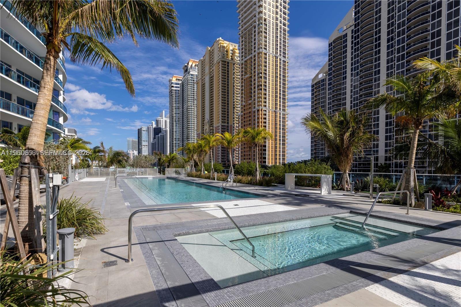 Experience elevated island living in this exceptional corner residence at Aurora — a boutique luxury building offering only 61 exclusive residences in the heart of Sunny Isles Beach, just steps from the beach, restaurants and shops. A private entry elevator welcomes you into a sophisticated interior featuring soaring 10-foot ceilings, floor-to-ceiling windows, and expansive sliding glass doors that seamlessly extend to a generous wraparound balcony — the perfect setting for entertaining or enjoying the privacy and tranquility of this desirable corner home. Designed with refined finishes throughout, the residence showcases elegant porcelain flooring, custom Ital-Kraft cabinetry, and premium Wolf and Sub-Zero appliances, delivering both style and functionality. Residents of Aurora enjoy an exceptional 5-star amenity collection thoughtfully designed for all ages, offering a true resort-style lifestyle in one of South Florida’s most sought-after beachside communities. The property allows 30-day minimum rentals up to 12 times per year, presenting an outstanding opportunity for both personal enjoyment and income potential.
A must-see residence combining luxury, location, and flexibility. Call today for your private showing.