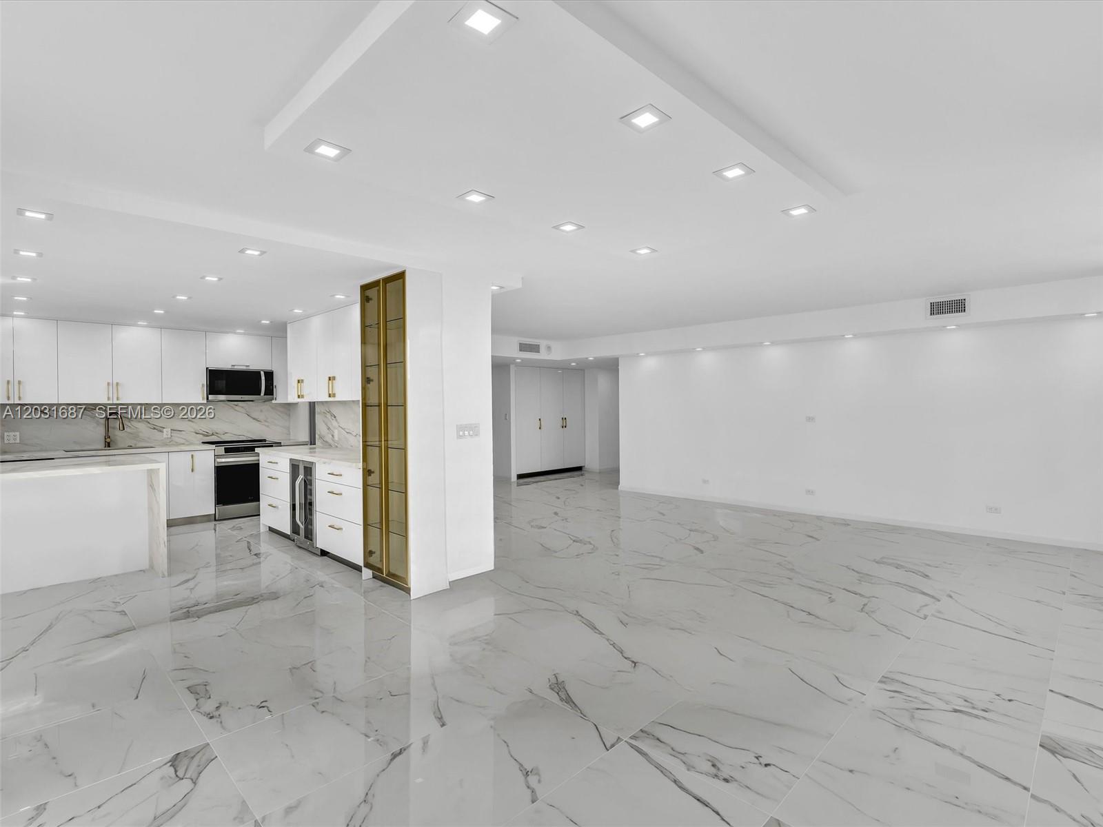 Step into luxury living in this fully remodeled corner 2-bedroom, 2-bath residence featuring the largest 2-bedroom floor plan in the entire Winston Towers community. This ultra-modern home has been professionally redesigned to deliver a seamless blend of sophisticated style, everyday functionality, and smart-living upgrades. The interior showcases a brand-new modern kitchen with stainless steel smart appliances, custom details, and generous counter space ideal for both cooking and entertaining. Custom-built, fully air-conditioned closets and pantries provide exceptional comfort while preserving stored items. Premium stone flows throughout the countertops and floors, accented with refined gold inlay and designer hardware that add elegance and cohesion. Hurricane-impact windows enhance safety, energy efficiency, and peace of mind, while every room reflects thoughtful design that balances beauty and practicality. The building offers unmatched reassurance as the only Winston Towers property to have completed both the 40-year and 50-year recertifications. Ideally located near top-rated Florida schools and just a minute’s walk from the beach, as well as restaurants, cafes, and shopping. Residents enjoy resort-style living with a fully renovated pool and community amenities. This move-in-ready residence has been completely reimagined, offering a rare opportunity to be the first to enjoy a meticulously designed home with modern comfort and lasting value.