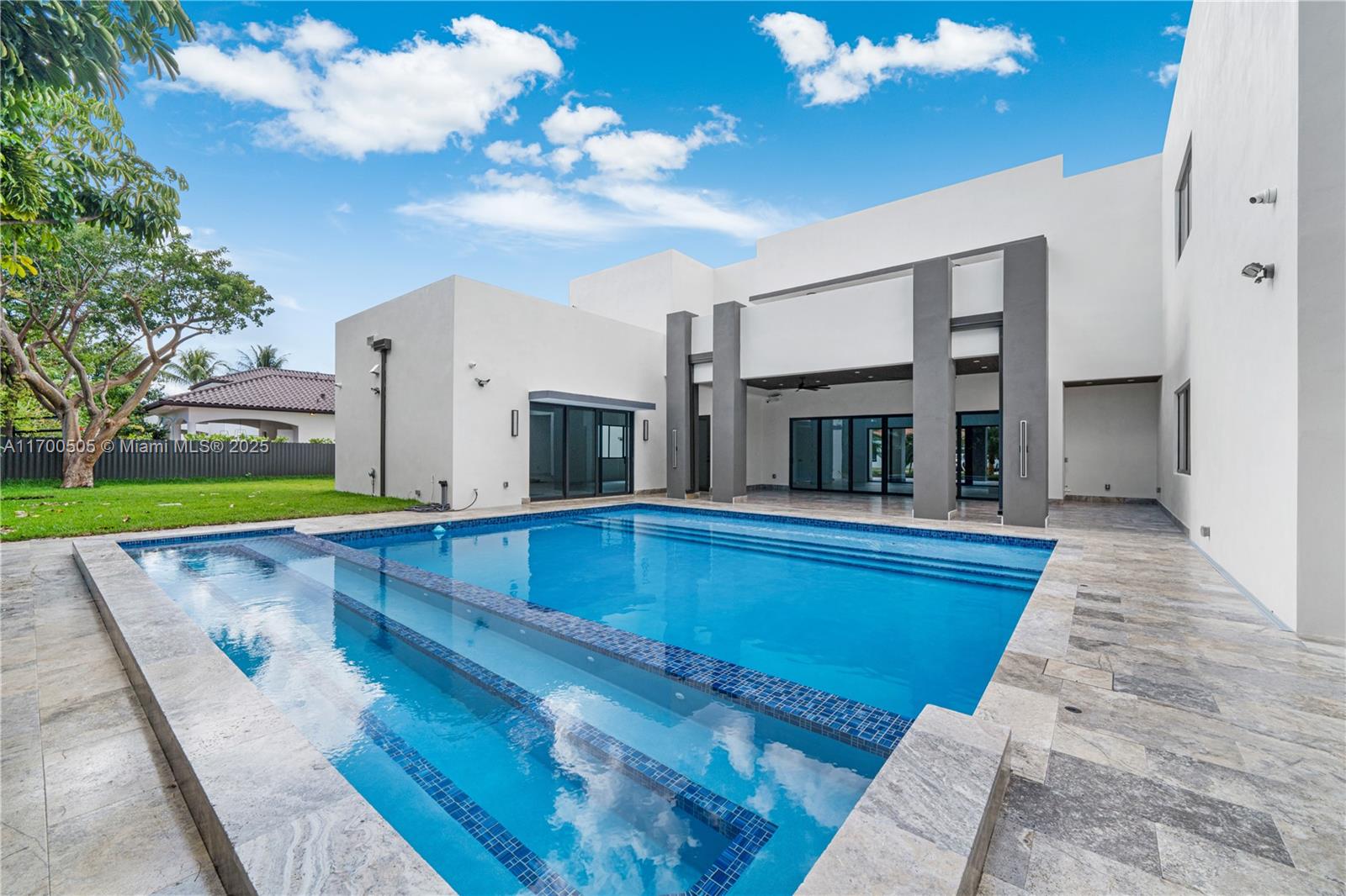 Brand-new, all-concrete mid-century modern home is the ultimate fortress. No trusses, never need roof replacement. Enjoy 3 expansive outdoor terraces perfect for taking in stunning sunsets. Fully equipped w/ smart technology, offering high-speed Wi-Fi & cable access. From electric car charging station to 16 security cameras, all controllable from the palm of your hand. Private paradise featuring heated pool & jacuzzi w/ bubblers, laminar jets & relax under umbrellas in pool beach area. Inside there's spacious master suite & 2 large en-suite bedrooms on both floors. 2 laundry rooms, 1 on each floor, can double as maid’s quarters/office spaces. This hurricane-proof, termite-proof concrete home is built for lifetime of modern living.