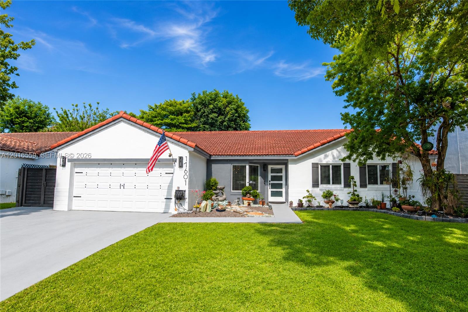 Beautifully updated single-story home featuring an open-concept layout with abundant natural light, vaulted ceilings, and stylish modern finishes throughout. The remodeled kitchen offers quartz countertops, stainless steel appliances, custom cabinetry, designer lighting, and an oversized island perfect for entertaining. Spacious living and dining areas flow seamlessly to the backyard through large sliding glass doors, creating ideal indoor-outdoor living. Newly installed impact window and Doors, New Roof. 

Step outside to a private tropical backyard and paved terrace, lush landscaping, mature palm trees, decorative lighting, and plenty of room for gatherings and relaxation. Unique outdoor touches and charming curb appeal make this property truly stand out. Conveniently located near shopping, dining, schools, and major highways.
Move-in ready and full of character — a perfect blend of modern upgrades and cozy South Florida living.