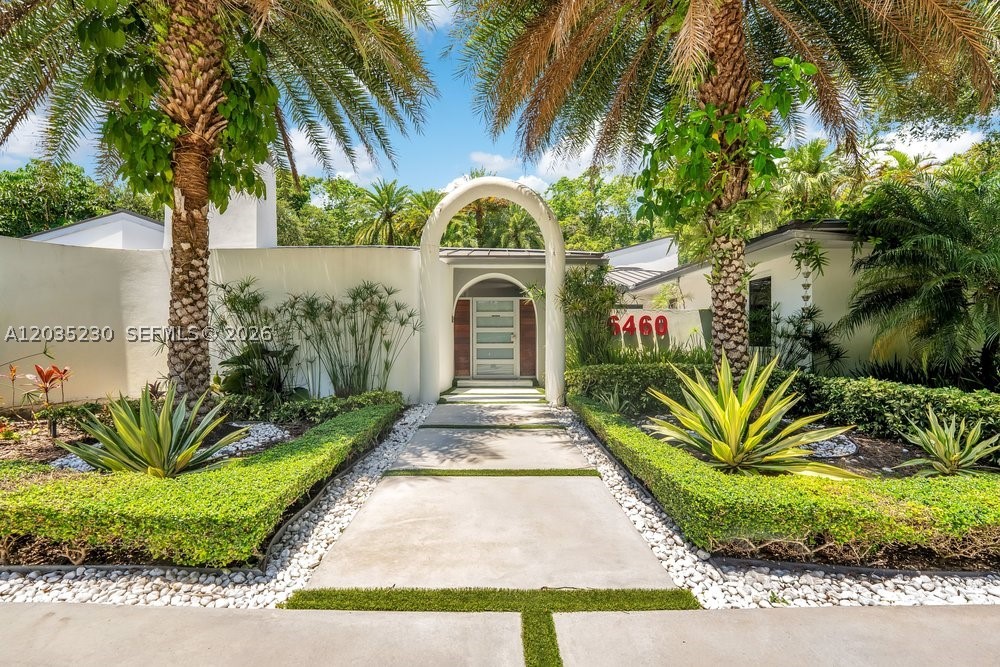 Spectacular renovated from floor to ceiling, this 4-bedroom plus office 5-bath house showcases incomparable amazing amenities. Walls of glass overlook lush tropical grounds. Enjoy a state-of-the-art theater with a 133” screen, summer kitchen, 12-hole putting green, gorgeous pool deck with top-of-the-line lounge chairs, saline pool and spa, 2-car garage, and parking for 8–10 cars. Very modern Lutron automation system throughout the entire property, with remote monitoring from 13 security cameras. Additional upgrades include a diesel generator, three in-duct AC air purifiers, and speakers throughout the property.