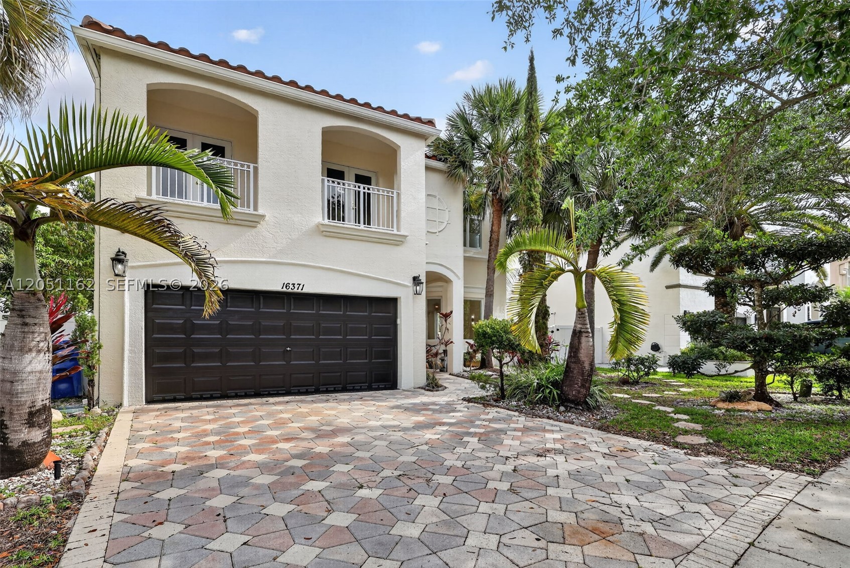 Welcome to this beautifully renovated 5/2.5 with a swimming pool. Home offering the perfect blend of comfort, style, and functionality. This property features brand-new impact windows and doors, providing both peace of mind and energy efficiency. Brand new AC downstairs, roof was done in 2021. Step inside to elegant marble flooring that flows seamlessly throughout the living spaces, creating a bright and sophisticated atmosphere. The thoughtfully updated interior offers a modern feel while maintaining a warm and inviting ambiance. Enjoy outdoor living at its finest with a fully equipped outdoor kitchen—perfect for entertaining guests or relaxing with family year-round. This move-in-ready home is a rare opportunity combining quality upgrades with timeless finishes. Conveniently located near shopping, dining, and major highways, it offers both luxury and accessibility.