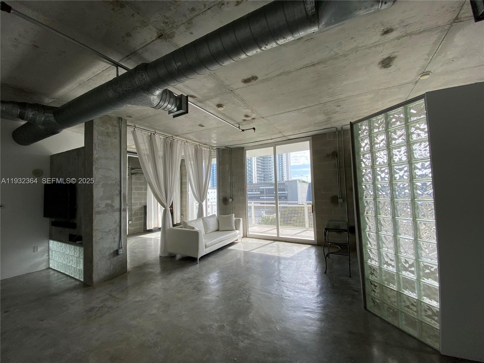 Experience contemporary living at The Yorker, a boutique condominium in the heart of Edgewater. This spacious 2-bed/2-bath split-floor-plan loft features 10-ft ceilings, polished concrete floors, a large terrace, and abundant natural light. Impact windows ensure quiet comfort throughout. Enjoy a prime location just 15 minutes from Miami International Airport and steps from Whole Foods, Trader Joe’s, Midtown, and vibrant cafés. The unit includes one covered parking space and a private storage unit. The building offers secure entry, fitness center, and pool, surrounded by new luxury developments that continue to elevate the neighborhood.