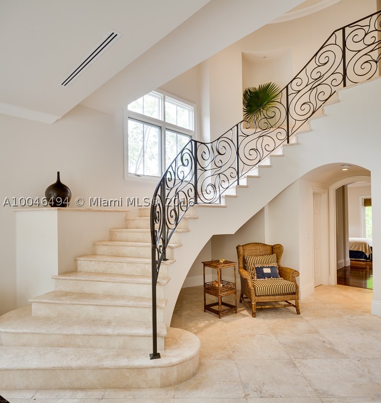 NEW PRICE! The home you've always wanted & certainly deserve: 1 of 11 estates in the Grove's private Hughes Cove, this 6-BR/6.5-BA home features formal living, dining & family rooms, chef's kitchen, volume ceilings, grand curved staircase & elevator & marble & wood floors throughout. Spacious master w/ sitting room & expansive covered poolside entertaining area. 4-car garage, 24-hr security, tennis court & private park overlooking the bay. Here's your chance to live in this exclusive waterfront community!