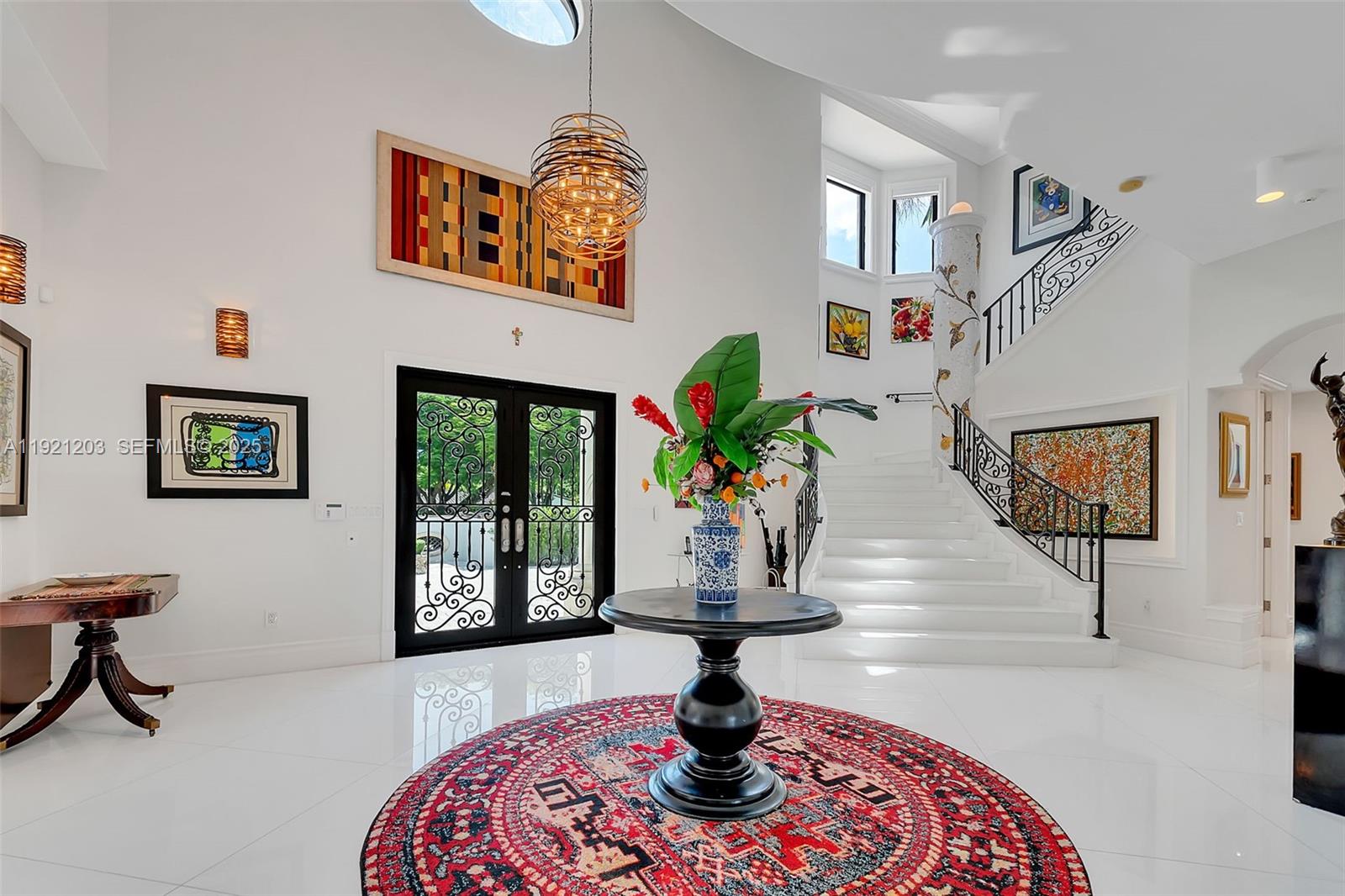 An exquisite Miami villa that defines luxury living. This 9-bedroom, 8-full bath, 2-half bath estate offers a level of elegance rarely found, blending timeless design with resort-style amenities. Enter through lush tropical grounds to a shimmering saltwater pool, spa, and refined poolside cabana. The expansive covered terrace frames a serene fountain and pond, while the rooftop oasis—with its own cabana—creates a truly extraordinary setting for sophisticated entertaining. Inside, brilliant white ceramic floors, a sweeping grand staircase, private elevator, and PGT Miami-Dade impact windows and doors elevate every detail. A maid’s/in-law suite and laundry chute add comfort and convenience. The primary suite is a sanctuary of indulgence, complete with a fireplace, dual custom closets, and opulent his-and-hers bathrooms with separate tub and shower. A masterpiece of elegance in the heart of Miami.