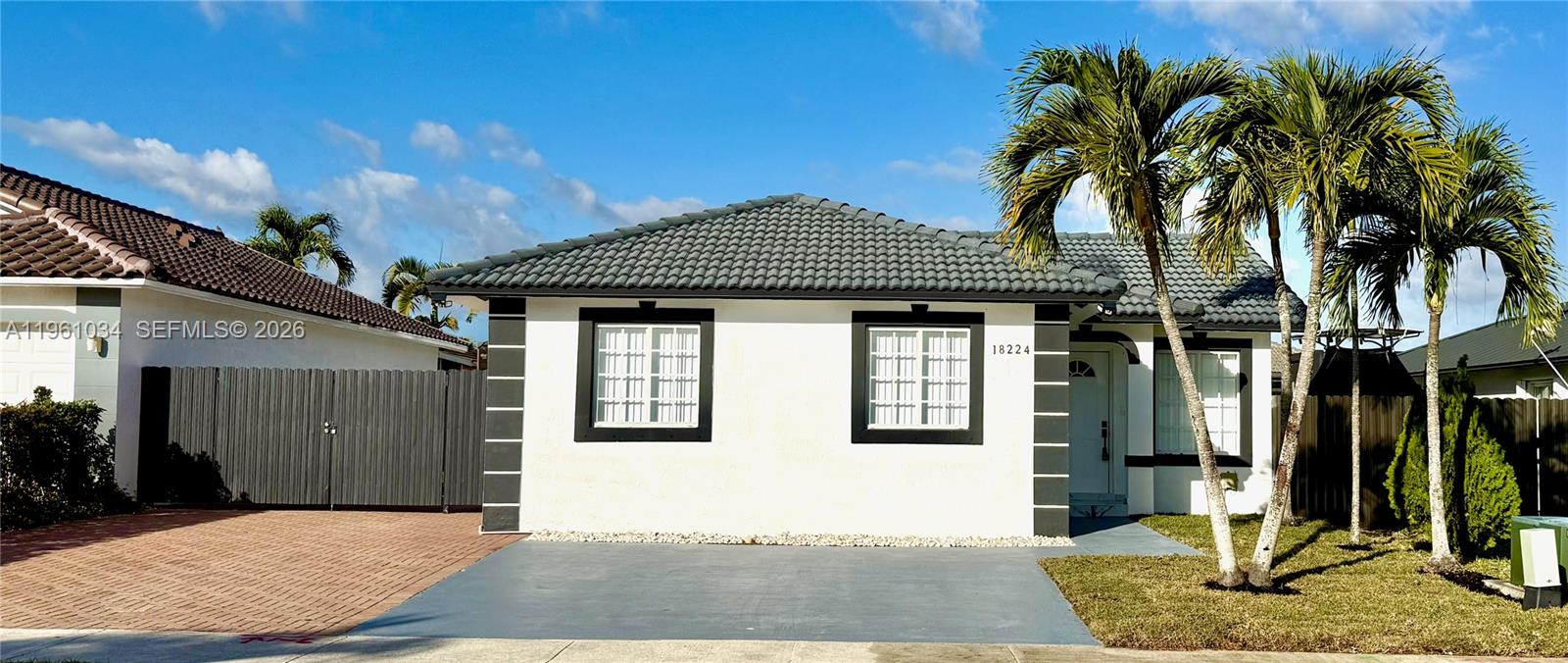 This upgraded 4-bedroom, 2-bathroom home offers a blend of modern design and functional utility, available without the restrictions of a Homeowners Association (HOA). The interior features an open-concept layout with new stainless steel appliances, modern shaker cabinets, and durable porcelain tile flooring throughout. The kitchen is highlighted by Calacatta Quartz countertops, including a large center island with a waterfall edge. Both bathrooms are updated with walk-in showers and frameless glass; the master bath is fitted with dual sinks and dual shower heads. The home also includes a tankless water heater for efficiency and a fully sprinklered front lawn for easy maintenance. The fenced-in backyard provides a private area for gatherings, has room for a pool, and includes a dedicated, paved area for parking an RV or boat.