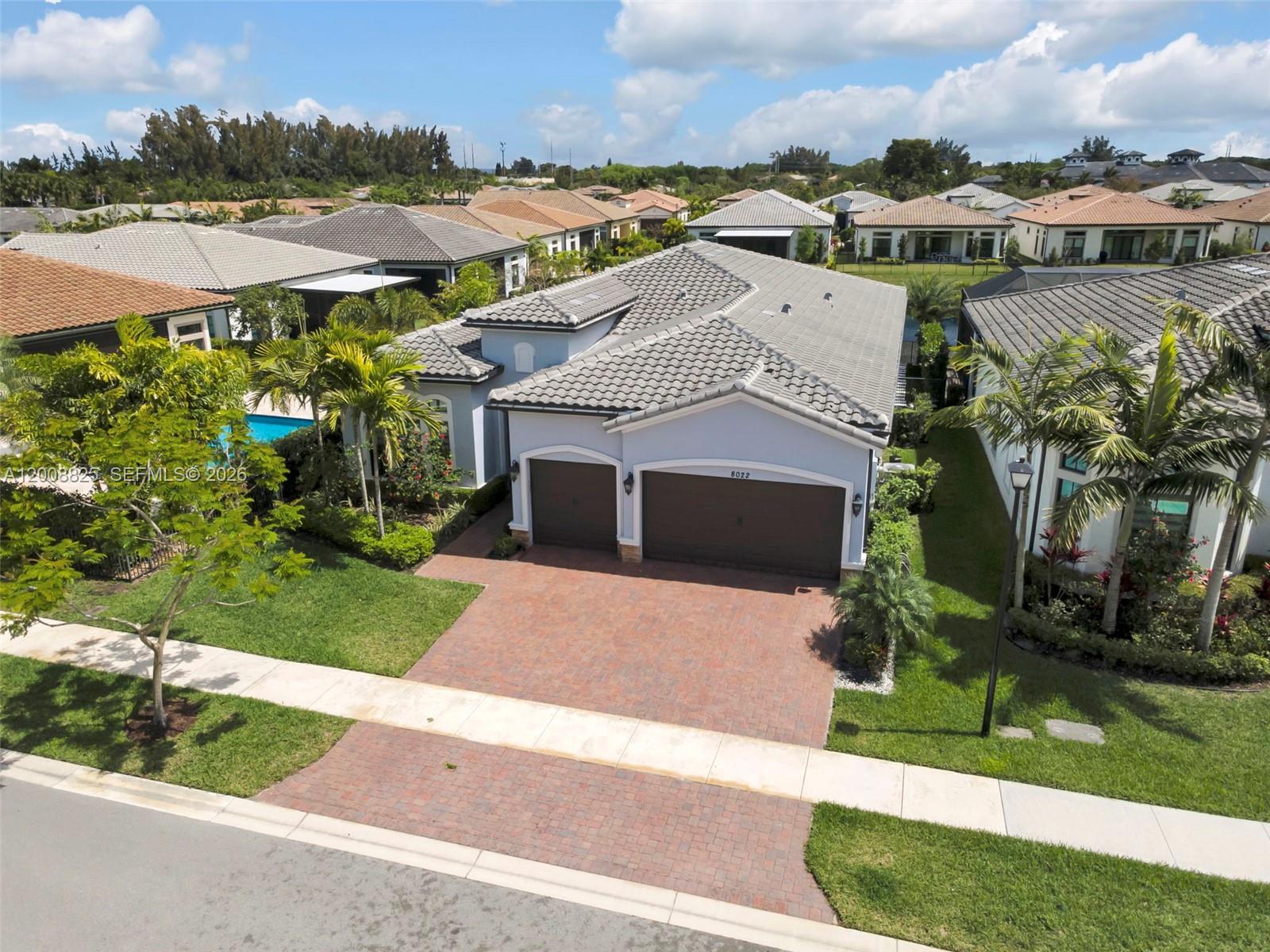 Meticulously upgraded 3BR/3.5BA home offering 2,613 sq ft of refined living with high-end finishes throughout. Features include custom closets in all bedrooms and spa-like baths with floor-to-ceiling tiled showers. The chef’s kitchen showcases a 10’x6’ quartz island with built-in storage, double wall ovens, and a fully customized walk-in pantry.

The living area is enhanced by a porcelain media wall, floating media center, and premium Sonos surround sound. Motorized Hunter Douglas shades in the main living areas provide effortless light control and showcase serene pool and lake views. The primary suite offers a luxurious custom walk-in closet and direct access to the backyard.

Step outside to a true resort-style oasis featuring a fully equipped outdoor kitchen with pizza oven, gas grill, smoker/charcoal grill, griddle, burners, built-in refrigerator, ice drawer, sink, and large granite island. Enjoy a heated saltwater pool and spa with sun shelf, waterfalls, and a gas fire pit overlooking the lake. Motorized floor-to-ceiling screens allow for a fully enclosed or open-air experience.

Additional highlights include a 3-car garage with epoxy flooring and custom cabinetry. A rare blend of luxury living and exceptional indoor-outdoor entertaining.