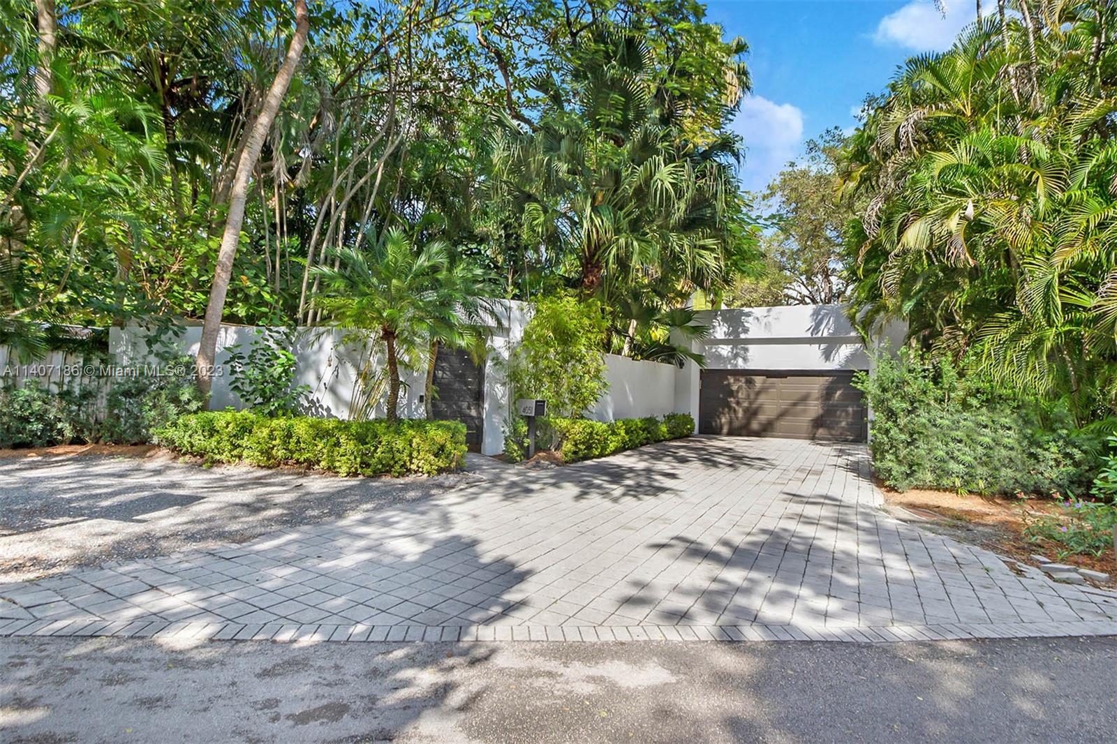 Hidden behind a tropical gated entrance you will find a one-story modern home recently renovated and available to lease. Fabulous gourmet gas kitchen with new designer cabinetry. Equipped with all new impact glass windows and doors and 3 new HVAC systems. The main house has a split plan with 3 bedrooms and two and a half bathrooms and two car garage. The 4th bedroom is a separate cottage with a family room, bedroom, kitchenette, and full bathroom. You will love hanging out in the Miami sun and indulging in the heated saline swimming pool recently all redone. Your tropical paradise awaits you in South Florida in the adored South Coconut Grove community. Central location close to the best public and private schools, Coral Gables, downtown, and Miami International Airport.