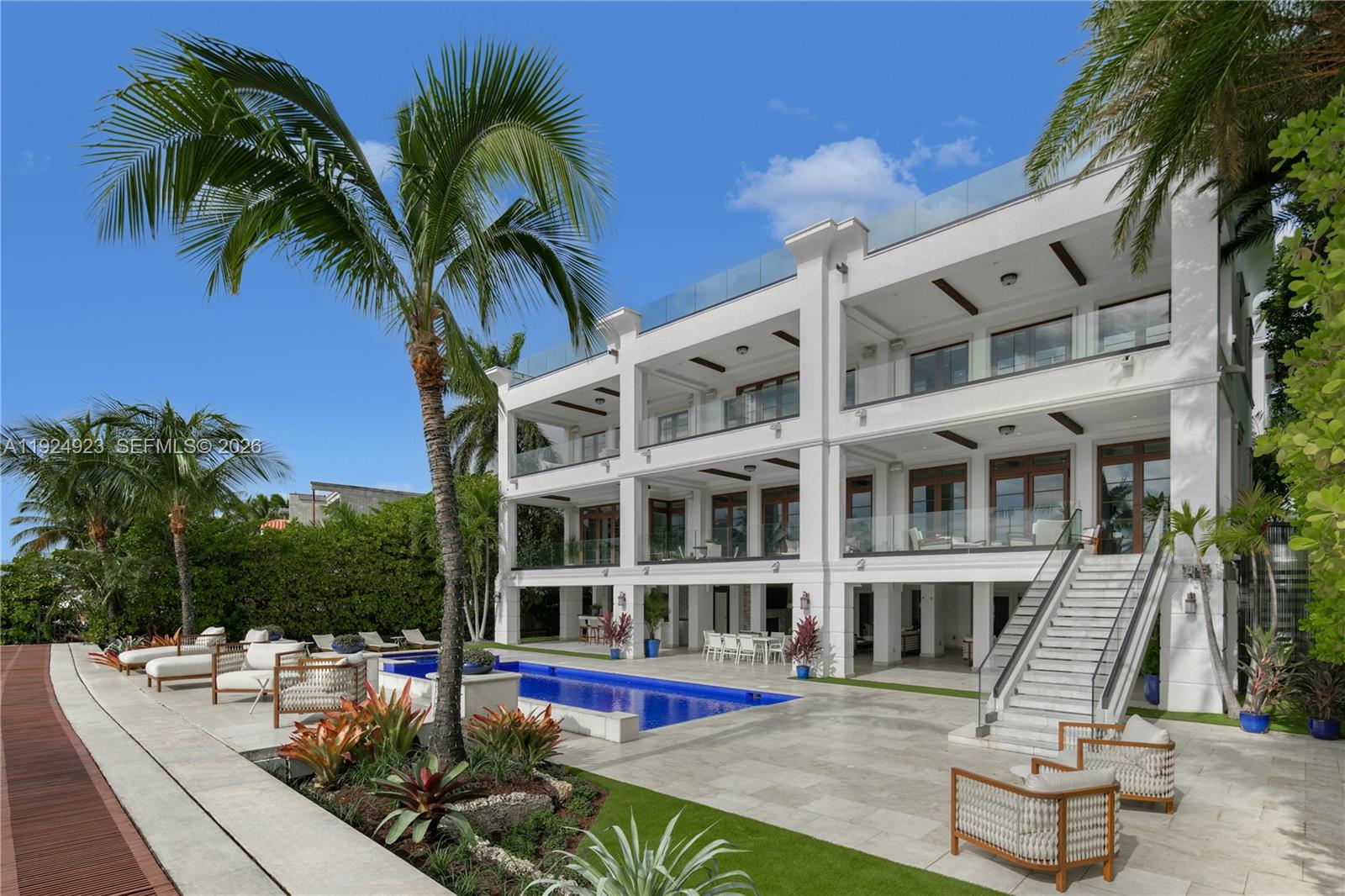 Experience luxury living in this exquisite 3-story waterfront estate, offering 100’ of prime water frontage on the prestigious, guard-gated Palm Island. Boasting 8 bedrooms, 9.5 baths, and a 4-car garage, this home offers ultimate comfort and style. Enjoy breathtaking views of the Miami skyline and beautiful sunsets from the expansive 5,000 SF rooftop terrace and multiple inviting living spaces. The ground level includes a spacious media room and game area while the outdoor space features a stunning pool, summer kitchen and a private dock that accommodates yachts up to 90' as well as a boat lift and floating jet ski dock. The home is complete with a private elevator and staff quarters. This is the epitome of elegance, exclusivity, and Miami’s vibrant waterfront lifestyle