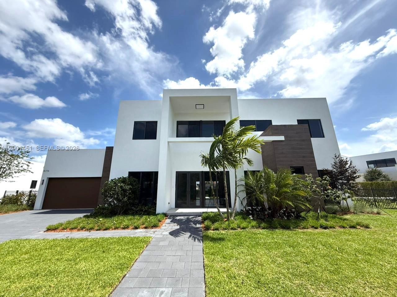 New construction located within the exclusive, private enclave of Botaniko Weston, one of the most desirable cities in South Florida. Designed by renowned architect PPK, the P3 model offers 5 bedrooms, 6.5 bathrooms, a media room/home office, and staff quarters, totaling 4,352 SqFt of air-conditioned living space. The home is pre-wired for motorized window treatments throughout.
The spacious, open-concept first floor features a formal living room, dining area, family room, and a guest bedroom with a walk-in closet. The chef-inspired kitchen is equipped with Wolf and Sub-Zero appliances, seamlessly blending style and functionality.
Upstairs, the primary suite is complemented by three additional en-suite bedrooms.
Step outside to your own private oasis featuring an exceptionally large backyard, enhanced by its prime corner, lakefront location, along with a summer kitchen and private pool—perfect for entertaining or relaxing. Additional highlights include a 2-car garage, 4 additional spaces in the driveway, and access to A+ rated schools.