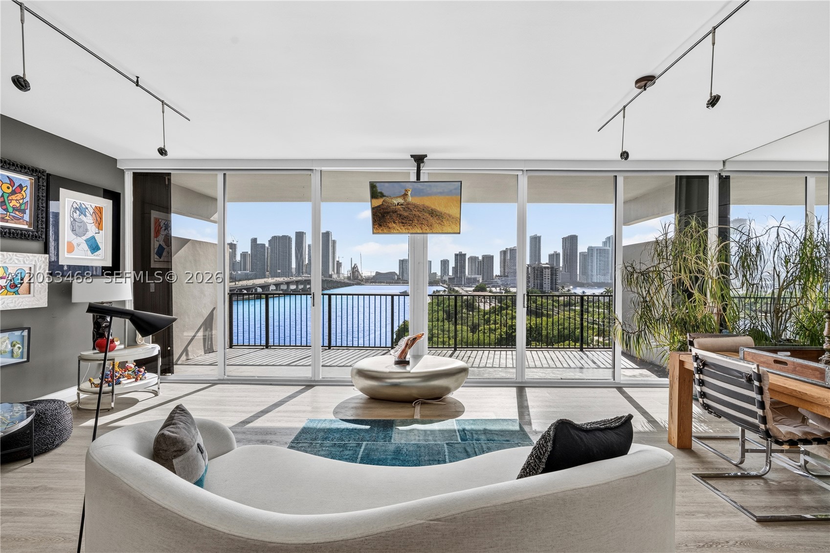 Direct open bay and city views set the stage for this modern industrial duplex on Venetian Islands, a fully gut renovated 1 bed, 1.5 bath residence offering 1,030 SF of interior living space and 320 SF across two private terraces. New flooring, doors and Farrow and Ball paint run throughout, while exposed cement walls and Venetian plaster carry the industrial modern aesthetic through both levels. A sculptural plexiglass staircase connects the two floors as a design moment of its own. The kitchen features Italian Stosa cabinetry and Porcelanosa countertops in Carrara marble and a synthetic blend chosen for easy care and no staining. Porcelanosa also supplies the flooring tile, shower and hexagonal steel backsplash. Set within 1000 Venetian Way, a boutique building with amenities including two pools, a fitness center, spa, dog park and concierge, this home offers privacy between Downtown Miami and Miami Beach.