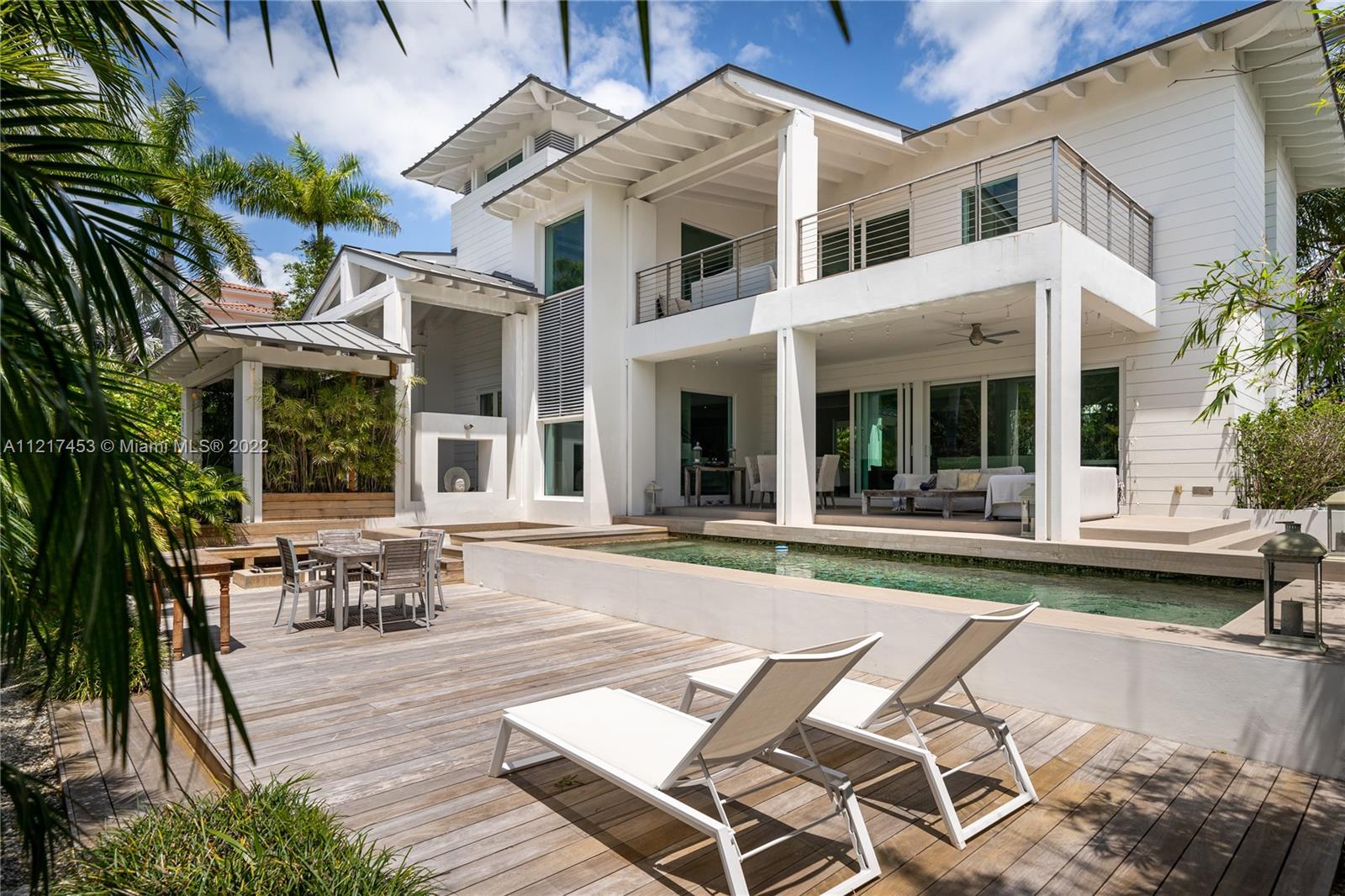 Contemporary Key West Style smart home ideally located on the prestigious Mashta Island! Rare opportunity to own a newly constructed home that has been exquisitely finished with elegant cutting edge interior design with top of the line appliances. No expenses were spared! This home offers high ceilings and an open flexible floor plan perfect for both families and /or individuals. This house features a contemporary bar, premium appliances, multiple terraces, resort like entertainment area with river stone pool and hot tub.