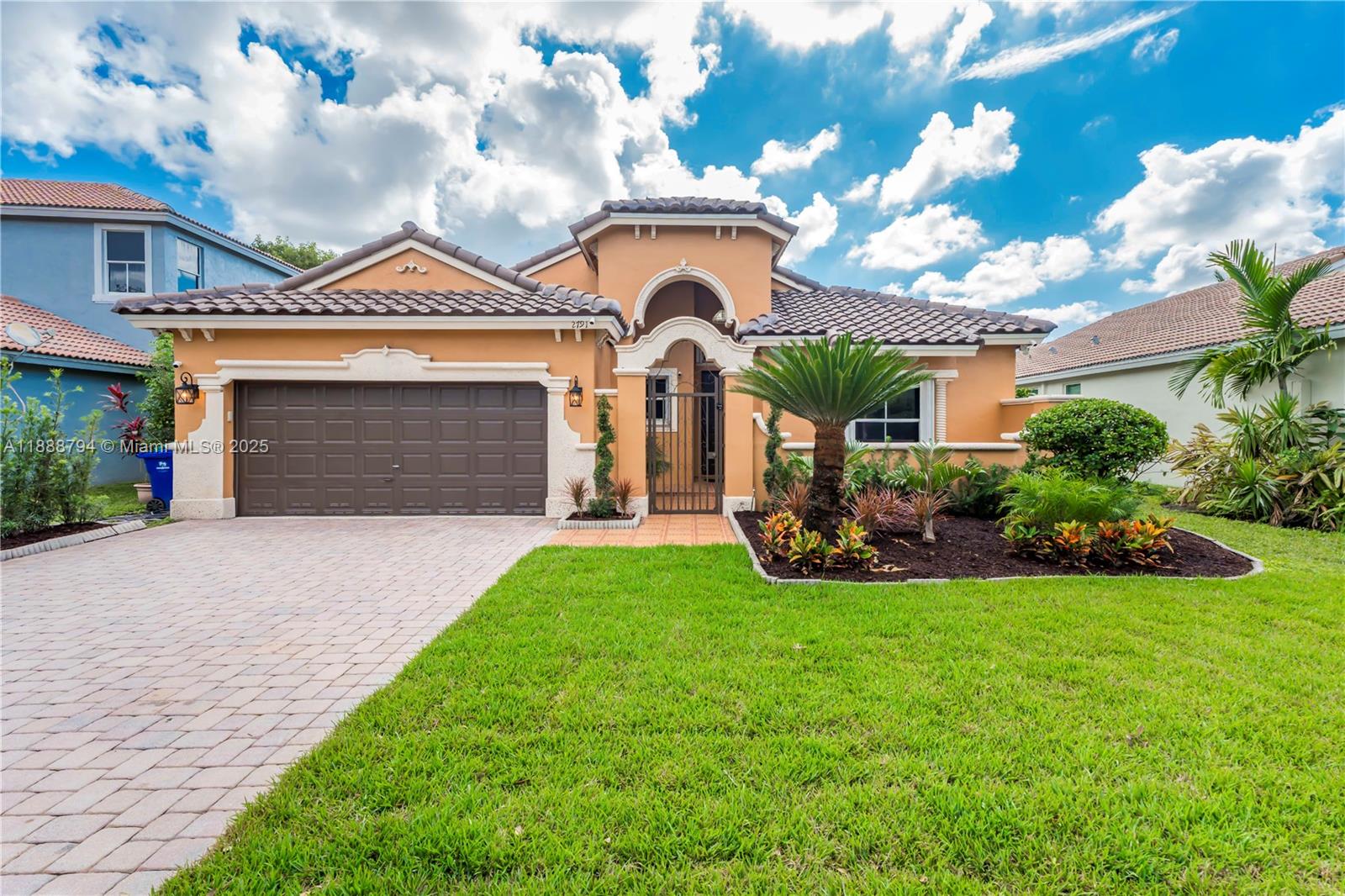 NEW ROOF!!! Enjoy stunning lake views from this beautifully updated home in the desirable Monaco Cove community! Featuring high ceilings and an open, airy layout, this property has been thoughtfully upgraded inside and out. Recent updates  new AC (2022), and brand new hardwood floors, fresh landscaping, and never-used kitchen appliances—all completed in 2025. Additional features include two updated bathrooms, accordion hurricane shutters, new garage cabinets and opener, upgraded ADT security with exterior cameras, and a Nest thermostat. Surrounded by mature tropical fruit trees—mango, papaya, avocado, soursop, guava, and more—this move-in ready home perfectly combines comfort, security, and peaceful lakeside living.