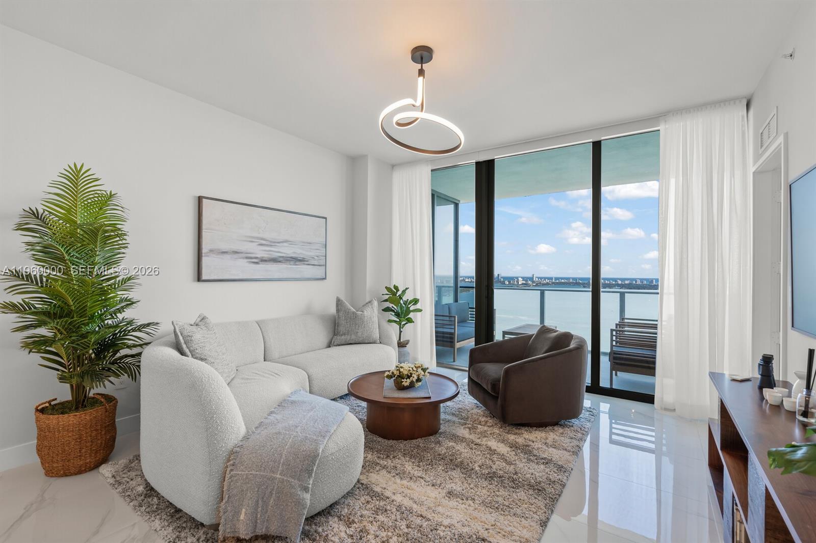 Luxury residence on the 39th floor of Aria Reserve with breathtaking panoramic views of Biscayne Bay and the Miami skyline. This never lived-in 1 Bedroom + Den, 2-bath residence features a modern design, spacious layout, and floor-to-ceiling windows that fill the space with natural light. Offered fully furnished and move-in ready, the unit includes electric curtains throughout, glass shower enclosures, LED-lit mirrors, and elegant finishes. The den provides flexibility for a home office or guest space.
Aria Reserve offers an exceptional resort-style lifestyle with a private sports marina, full-service spa, state-of-the-art fitness center, tennis, paddleball, squash and basketball courts, mini golf, dog park, and two pools with water views, including a semi-Olympic pool. Prime waterfront location with easy access to Miami Beach and Downtown.