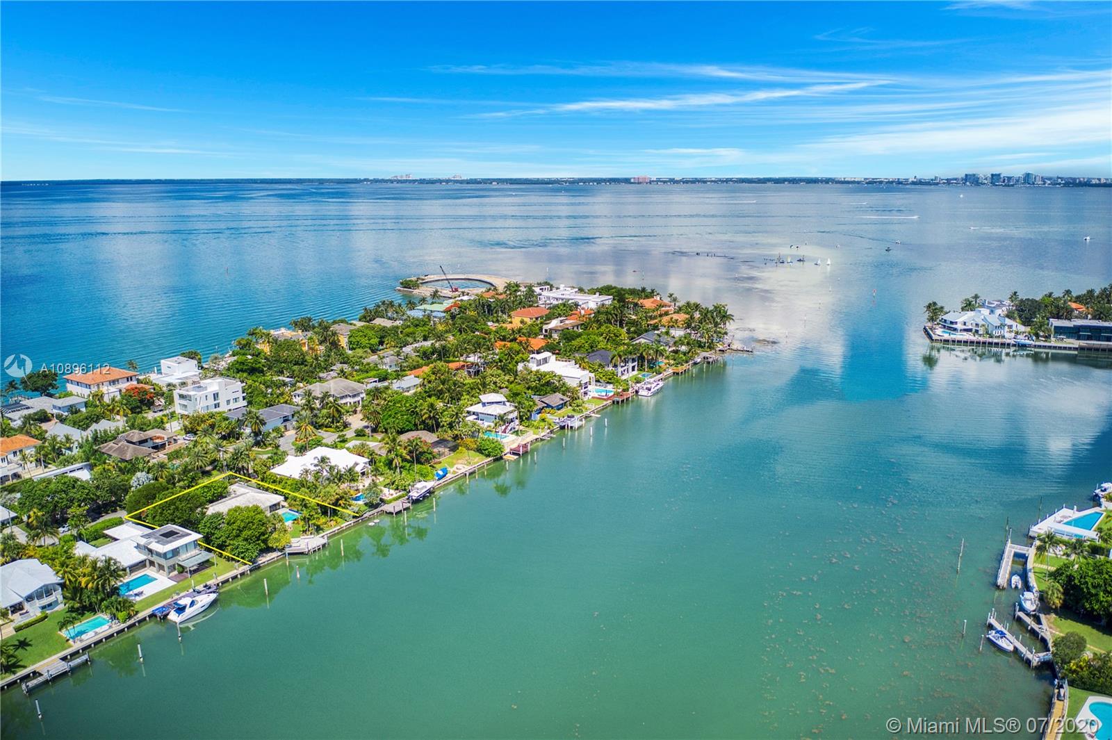 Charming waterfront home with 4 bed, 4 bath plus staff quarters.  Overlooking Key Biscayne’s Hurricane Harbor.  15,080 lot with 104 feet of water frontage. Great location for boat enthusiast.  Situated on the widest part of the protected harbor features boat Davits and an oversized dock.  Fantastic opportunity to transform this spacious home or build a tropical dream home on North Mashta Island. Living areas include two dens, separate dining and living room. Exterior features include covered patio, heated swimming pool. Full house generator included in sale.