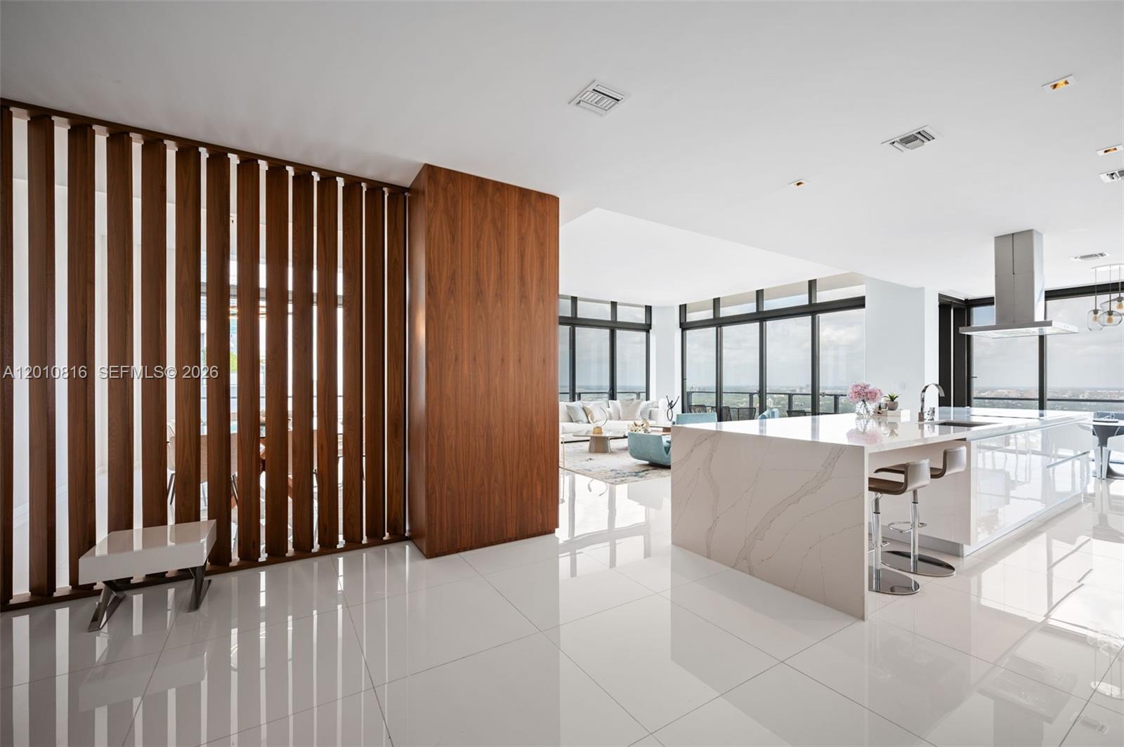 This is not just a residence—it is a statement penthouse at Rise, Brickell City Centre, where scale, design, and location converge to create a truly rare offering. Encompassing 4 bedrooms plus an enlarged den and 5.5 bathrooms, this exceptional corner home with 11' ceilings is defined by its grand proportions and uninterrupted water and city views, showcased from an extraordinary 1,035 square feet of wraparound balconies. Every detail has been curated for a refined, elevated lifestyle. Elegant porcelain flooring flows throughout, complemented by bespoke Italian cabinetry and a striking quartz island kitchen designed for both entertaining and everyday living. Spa-caliber bathrooms with sleek vanities and integrated automated shades add a layer of modern sophistication. Each bedroom is a private retreat with generous walk-in closets, while a full laundry room and separate staff’s quarters with a full bath provide seamless functionality without compromising discretion. With three assigned parking spaces convenience is effortlessly integrated into this distinguished home. Positioned above Brickell’s most prestigious destination for luxury shopping and dining, this penthouse represents a rare opportunity to own one of the most significant residences in the building and Brickell.