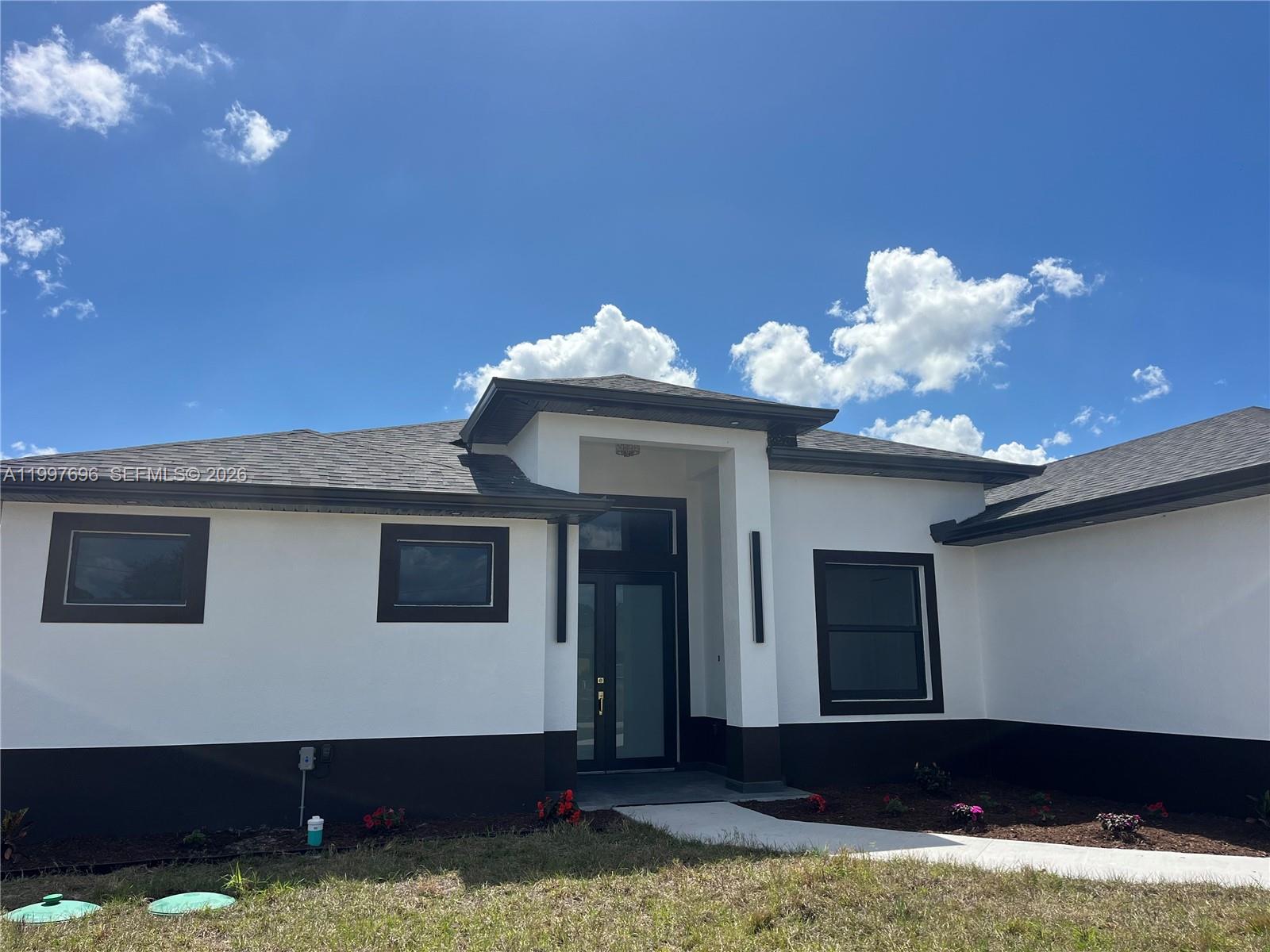 Stunning New Construction in a highly desired Lehigh Acres neighborhood. This modern home features 3 Bedrooms plus a Den with a closet (easily a 4th Bedroom), high-end impact windows, and sleek modern tile throughout. The gourmet kitchen boasts premium quartz countertops waterfall island, Double Wall Oven. Open Family Room. Stainless Steel Apiances and Exterior Summer Kitchen. Located in a top-tier area preferred by buyers. Seller offering closing cost assistance!