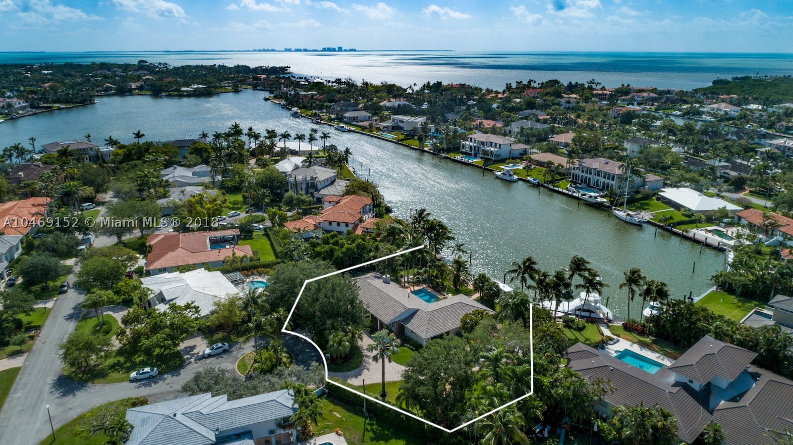 Wide water views and no bridges to Biscayne Bay. Serene waterfront home in the beautiful gated community of Old Cutler Bay, a quiet, traffic free secluded compound. This home has plenty of charm, is positioned in the nook of a cul-de-sac, and offers a sprawling tropical backyard and surrounding mature landscaping. A boater’s dream with more than 120 ft of water frontage, a boat lift and desirable prevailing SE breezes on pool, patio. Restore or build your picture-perfect home.