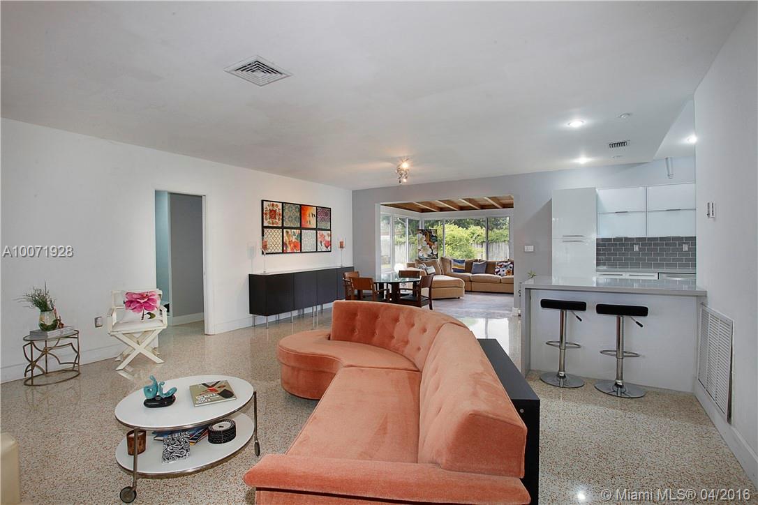 Bright, open, renovated, modern and spacious--everything you want to hear about your new place.  Fabulous renovation with gorgeous terrazzo and polished concrete floors, sleek new kitchen and baths.  Nicely sized master bedroom.  Huge living room, family room with wrap around windows overlooking private fenced 10,000SF yard. Bonus room for private office or possible fourth bedroom, and separate laundry room. Great South Miami neighborhood, close to UM. Includes yard maintenance.  You'll love living here!