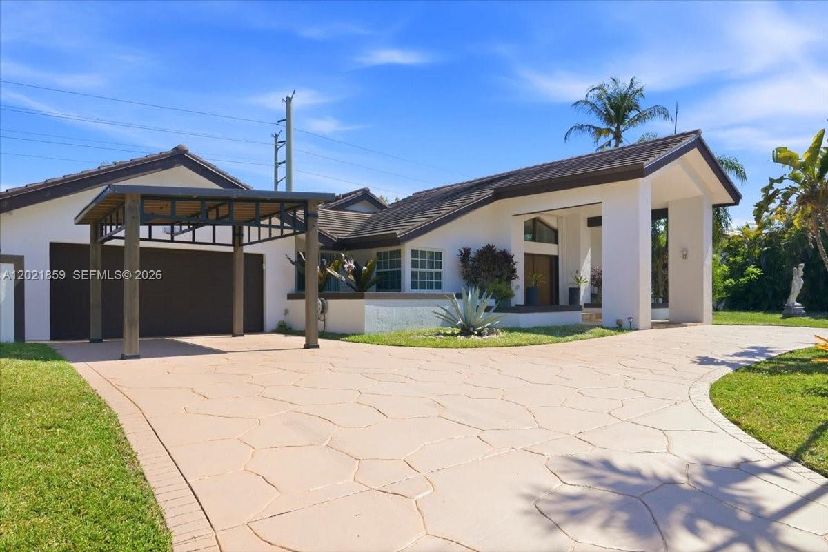 Executive home presented in the sought after neighborhood of The Falls. This remodeled Luxury property offers 5 bedrooms and 4.5 baths, with over 3,600 sq ft and oversized 17,000 sq ft lot, 2 car garage, and impact windows. Marble and wood floors throughout, vaulted ceilings with tongue and groove in the living and dining areas. Kitchen showcases Viking and KitchenAid appliances, high end granite tops, island, built-in microwave and steam convection oven. Bedroom closets are complete with organizers and baths with temperature-controlled showers. The Master bath includes Jacuzzi, shower with rainfall and massage jets. The covered terrace can also be transformed into a Florida room with custom sliding glass panels offering best of both worlds. Relax in the pool area and enjoy family time with built in BBQ and wet bar area under the pergola. Diverse types of fruit trees, such as mango, banana, orange, avocado, papaya, all sustained with well water pump and automatic sprinkler system. Roof is only 8 years old. Property has unique access from the rear of the property, providing boat storage or extra parking if needed and privacy. Conveniently located just minutes from The Falls shopping center. No Association.