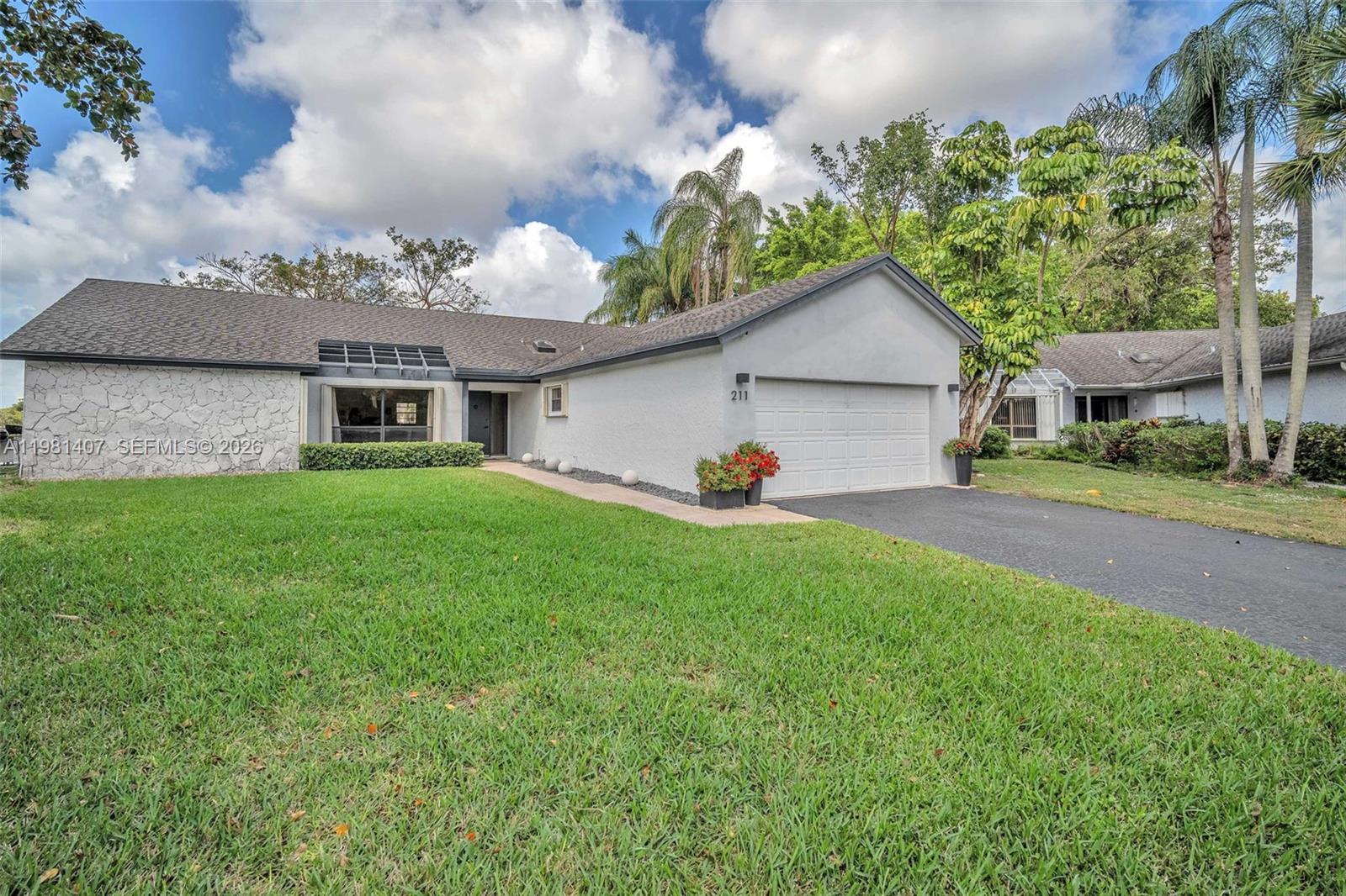 Experience refined So Florida living in this beautifully updated one story single family home perfectly positioned on the LARGEST LOT in the boutique community of Las Brisas. This home offers breathtaking lake and Jacaranda golf course views from every room creating a serene and private backdrop for everyday living & entertaining. The spacious, open floorplan with bright natural lighting features poured concrete throughout. LOW HOA, NEWER & NEW APPLIANCES AND AC, ACCORDION SHUTTERS THROUGHOUT,  A GENERATOR WITH TWO PROPANE TANKS. There is also an electric fence for your pets protection.(optional) A fence is allowed.  Community Pool and clubhouse.  Located close to highways, schools, shopping and restaurants.