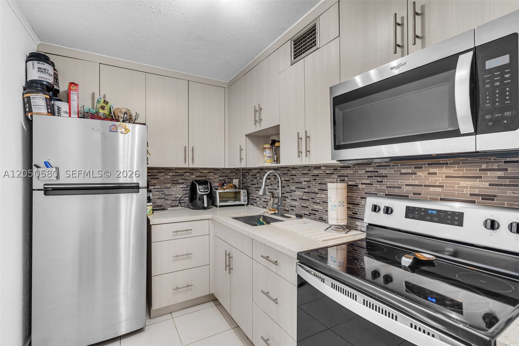 First-floor condo in the desirable Summit Chase community, offering the perfect combination of comfort, convenience, and accessibility. With no stairs or elevators, this home is ideal for those seeking easy access, including seniors, individuals with mobility needs, or anyone who appreciates the convenience of first-floor living. Inside, you'll find a bright and spacious living area highlighted by a distinctive decorative rock accent wall that adds warmth and character. The screened-in patio provides the perfect space to enjoy your morning coffee or unwind after a long day. The kitchen features stainless steel appliances, while the oversized walk-in closet offers exceptional storage. Residents of Summit Chase enjoy a wealth of community amenities, including 24-hour security, a sparkling swimming pool, tennis courts, and a clubhouse. The property includes one assigned parking space with plenty of guest parking available. Ideally located with quick access to SR 836 (Dolphin Expressway), the Florida Turnpike, shopping, dining, healthcare facilities, and major employment centers, this condo offers an unbeatable combination of lifestyle and location. The building has also successfully completed its 40-year certification, providing additional peace of mind for buyers.
This move-in-ready condo is one you won't want to miss.