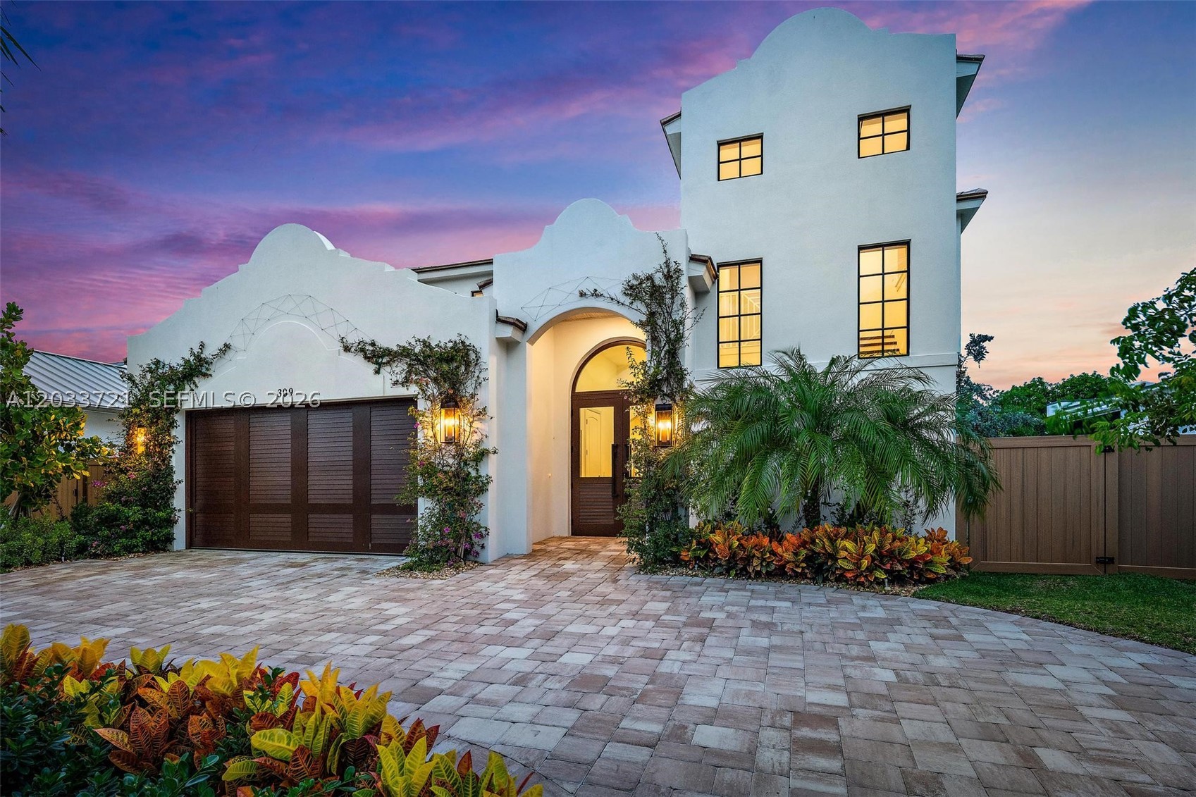 Located in Palm Beach Shores, this never-lived-in new construction home offers a rare opportunity to own a modern coastal residence just minutes from the beach, Palm Beach Inlet, Sailfish Marina, and local waterfront restaurants. The open floor plan is centered around a spacious kitchen with custom cabinetry, premium appliances, a large island, and seamless flow into the living and dining areas. Large impact glass doors open to the covered patio, creating an easy connection between indoor and outdoor living. The backyard features a heated pool, summer kitchen, covered lanai, tropical landscaping, and brand-new artificial turf, providing a clean, low-maintenance outdoor space.