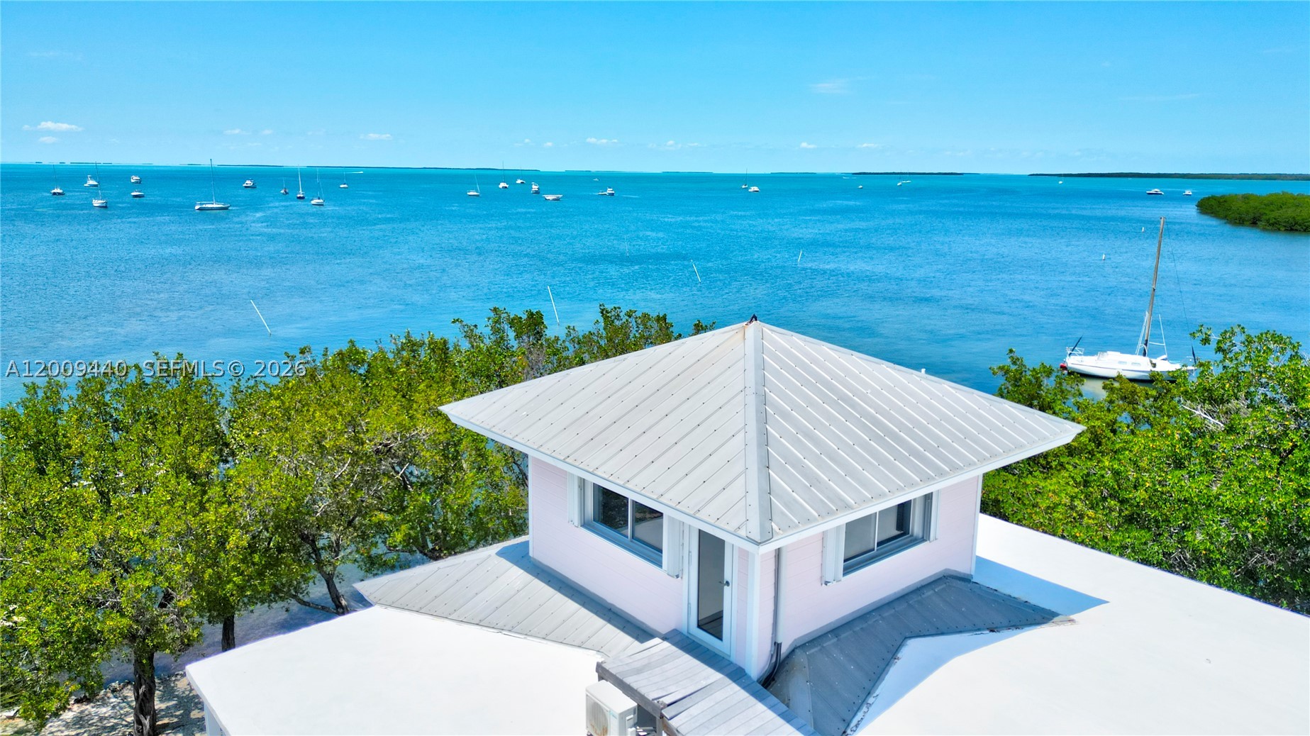 Spectacular Bayfront Estate with Guesthouse in the Heart of Islamorada. Seller Financing Available.

Experience luxury coastal living at its finest in this exceptional Gated bayfront estate, ideally situated in the heart of Islamorada. Set on a rare peninsula with over 225 feet of prime waterfront, this property offers unmatched privacy, panoramic views, and direct access to both the Florida Bay and Atlantic Ocean.

The main residence features 7 spacious bedrooms and 5 beautifully appointed bathrooms designed with both elegance and comfort in mind--perfect for entertaining or hosting large gatherings. A dramatic third-floor Bird's Nest Sky Lounge features 360-degree glass walls and a walkout rooftop deck, capturing breathtaking vistas in every direction. Expansive living areas and thoughtfully designed spaces capture stunning water views from every angle.

A private 1-bedroom, 1-bathroom guesthouse provides the ideal retreat for visitors, accommodating extended family, or potential rental income or creating a secluded retreat. 

For boating enthusiasts, the estate includes an impressive 85+ foot deep-water yacht slip and four boat lifts, offering seamless access to both the Bay and Ocean--an unparalleled fishing advantage in the Florida Keys.