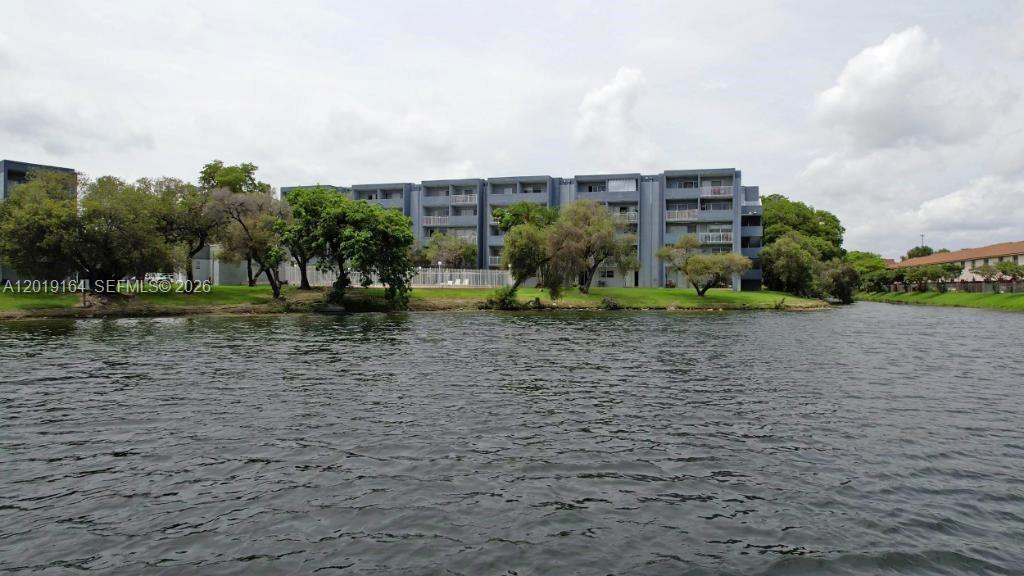 Wake up to breathtaking lake views and unwind to shimmering pool vistas from your private balcony. This bright, beautifully finished residence features sleek porcelain tile throughout and an open, sun-filled layout designed for effortless Miami living.

The showpiece kitchen impresses with rich granite counters, a center island, stainless steel appliances, and crisp white cabinetry with stylish glass-front uppers. The bedroom offers a built-out walk-in closet, and a versatile extra space with closet works beautifully as a den, home office, or guest room. In-unit laundry.

Resort-style guard-gated community: pool, tennis, playground, elevator, and a private sand beach with loungers along the lake. Minutes to shopping and dining. Some photos virtually staged. Schedule your tour today!