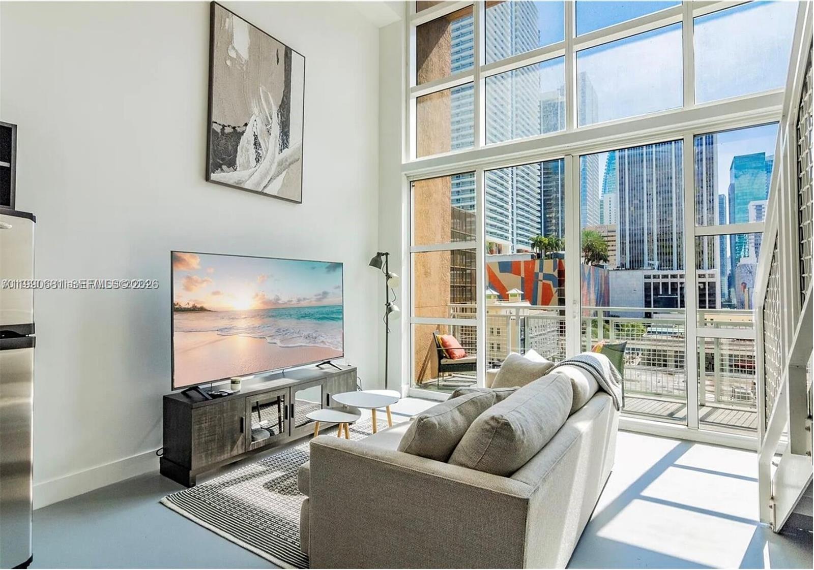 This two-story loft features all the upgrades a homeowner could desire including 19-foot floor-to-ceiling impact windows, electronic blinds and an upgraded kitchen, bathroom, and tile floors to complement your upscale lifestyle. It also includes a washer/dryer, assigned parking space on the same floor and valet service. Enjoy 4 pools with a poolside Tiki bar, indoor and outdoor hot tubs, a media room, a private spa, a party room with a pool table, a kitchen, and a bar. The unit comes with an extra storage space. The apartment is available for rent with a minimum lease of 30 days making it appealing to investors that focus on midterm rentals.