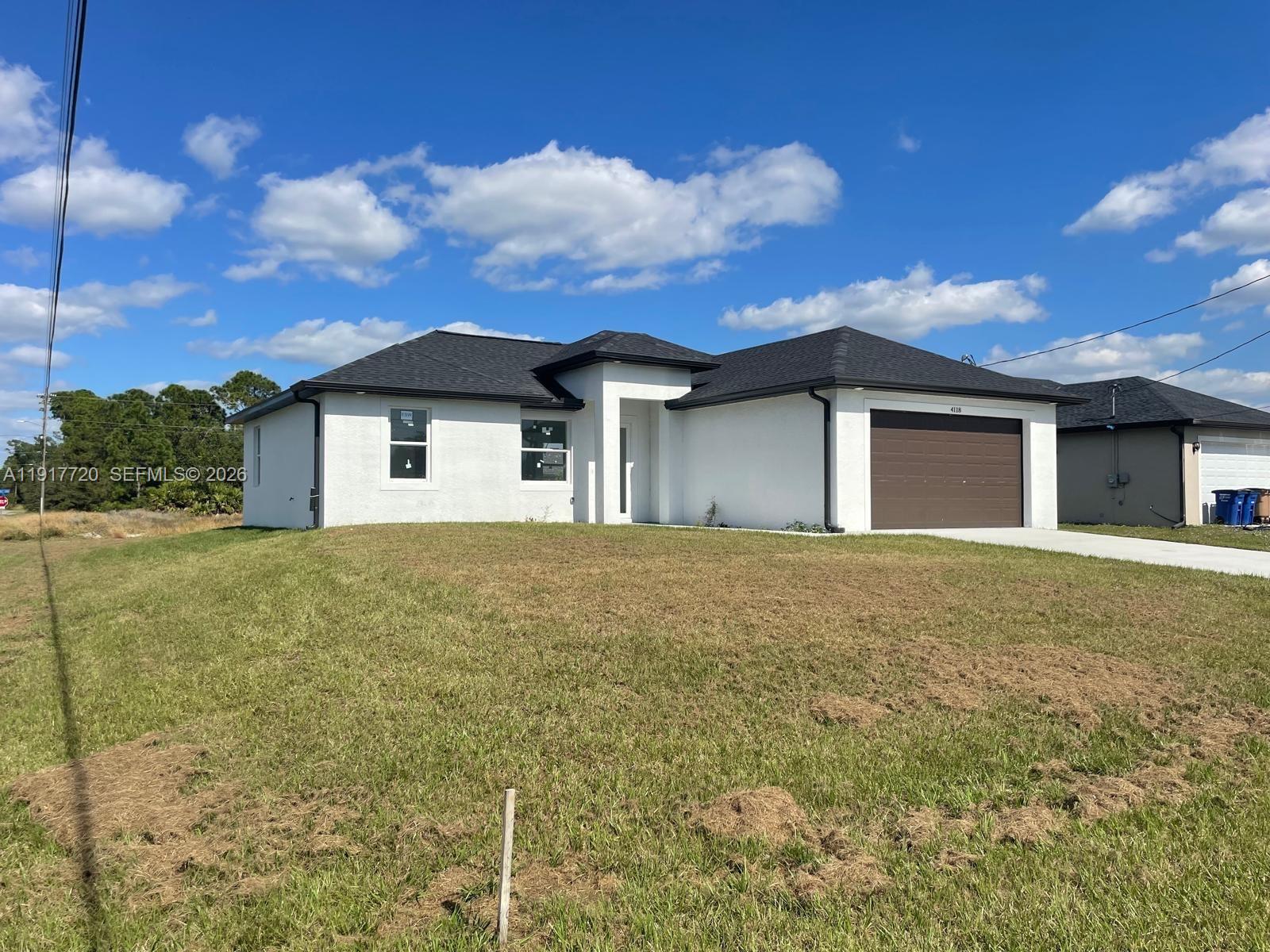 For sale! This charming brand-new 3-bedroom, 2-bath home in Lehigh Acres with an amazing corner lot! Featuring a split floor plan that provides space, comfort, and privacy. The modern kitchen includes stainless steel appliances and stylish finishes, while impact windows fill the home with natural light. Located on a corner lot, this property offers added privacy and a spacious backyard perfect for outdoor activities, with room for a pool or jacuzzi. It also includes a 2-car garage with extra storage and is situated in an excellent neighborhood close to schools, shopping centers, and restaurants. Ideal for both homebuyers and investors, with great rental potential.