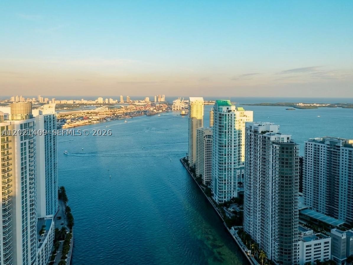 Experience elevated luxury living from the 50th floor at Epic Residences & Hotel. This stunning 2-bedroom, 2.5-bath residence offers breathtaking panoramic views of Biscayne Bay, the Miami River, Brickell skyline, Fisher Island, and South Beach through floor-to-ceiling windows and soaring 11-foot ceilings. The spacious split floor plan features large bedrooms, and an abundance of natural light throughout. The elegant primary suite includes a spa-inspired bathroom with dual sinks, a separate whirlpool tub, and glass-enclosed shower. The modern open kitchen is equipped with premium Miele appliances, while a Bosch washer and dryer are conveniently located inside the unit.One covered parking space. Enjoy world-class amenities and an unbeatable location just steps from Brickell, Bayside, Whole Foods, fine dining, shopping, and Miami’s vibrant nightlife. Tenant occupied - 24hr notice.