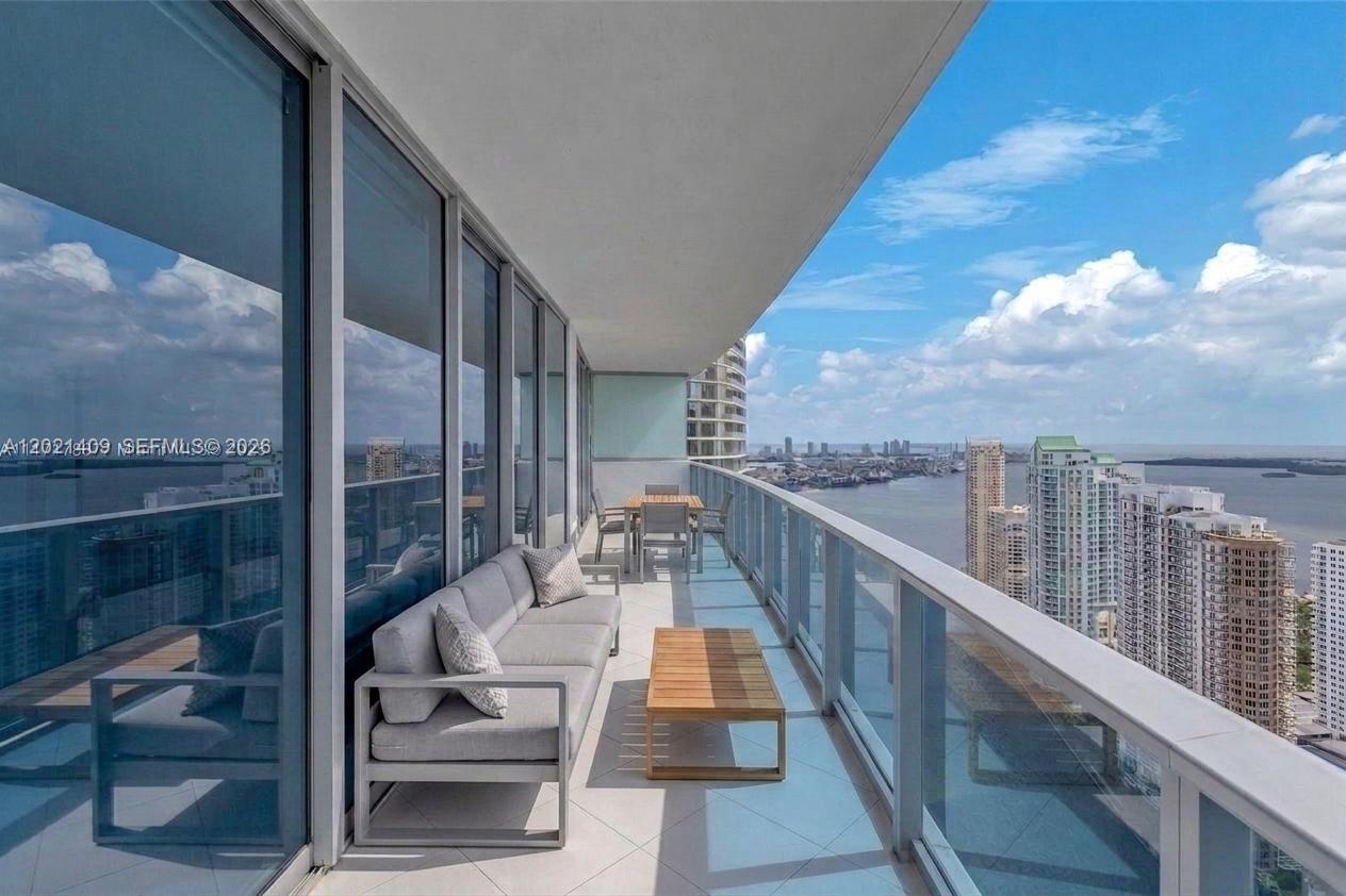 Experience elevated luxury living from the 50th floor at Epic Residences & Hotel. This stunning 2-bedroom, 2.5-bath residence offers breathtaking panoramic views of Biscayne Bay, the Miami River, Brickell skyline, Fisher Island, and South Beach through floor-to-ceiling windows and soaring 11-foot ceilings. The spacious split floor plan features large bedrooms, and an abundance of natural light throughout. The elegant primary suite includes a spa-inspired bathroom with dual sinks, a separate whirlpool tub, and glass-enclosed shower. The modern open kitchen is equipped with premium Miele appliances, while a Bosch washer and dryer are conveniently located inside the unit.One covered parking space. Enjoy world-class amenities and an unbeatable location just steps from Brickell, Bayside, Whole Foods, fine dining, shopping, and Miami’s vibrant nightlife. Tenant occupied - 24hr notice.
