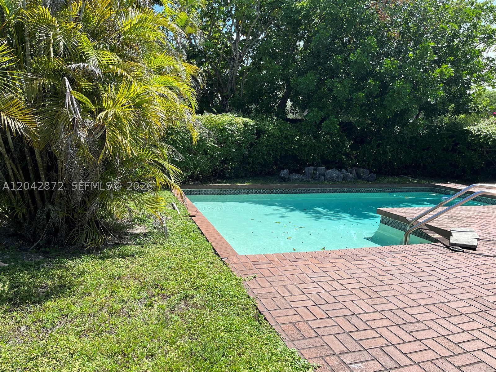 Beautiful 2/2+ den, 2-car garage. Private pool and patio. Oversized lot. New kitchen, roof, solar system and ductless mini split a/c. Full size washer/dryer. Gated security. Walk to shopping and park. Furnishings available for sale.