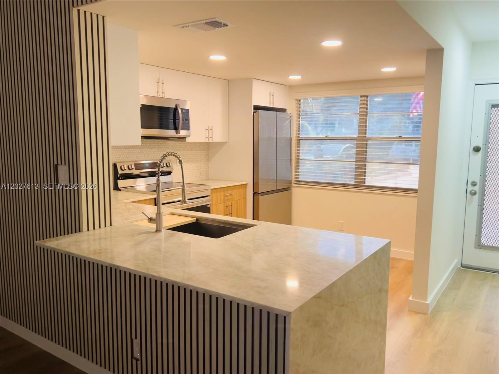 This brand new and beautifully remodeled 2/2, custom designed with modern finishes, offers a split bedroom plan, an incredibly spacious screened in patio, and large eat in kitchen. The most convenient condo living imaginable, with assigned parking located directly in front of the unit and the laundry room adjacent, there’s no need for schlepping to and from your vehicle or your home. The rear of the unit has private garden views, while offering access to the pool, only several steps away. The community offers an array of amenities and activities to accomodate all interests. This is truly a MUST SEE!!!
