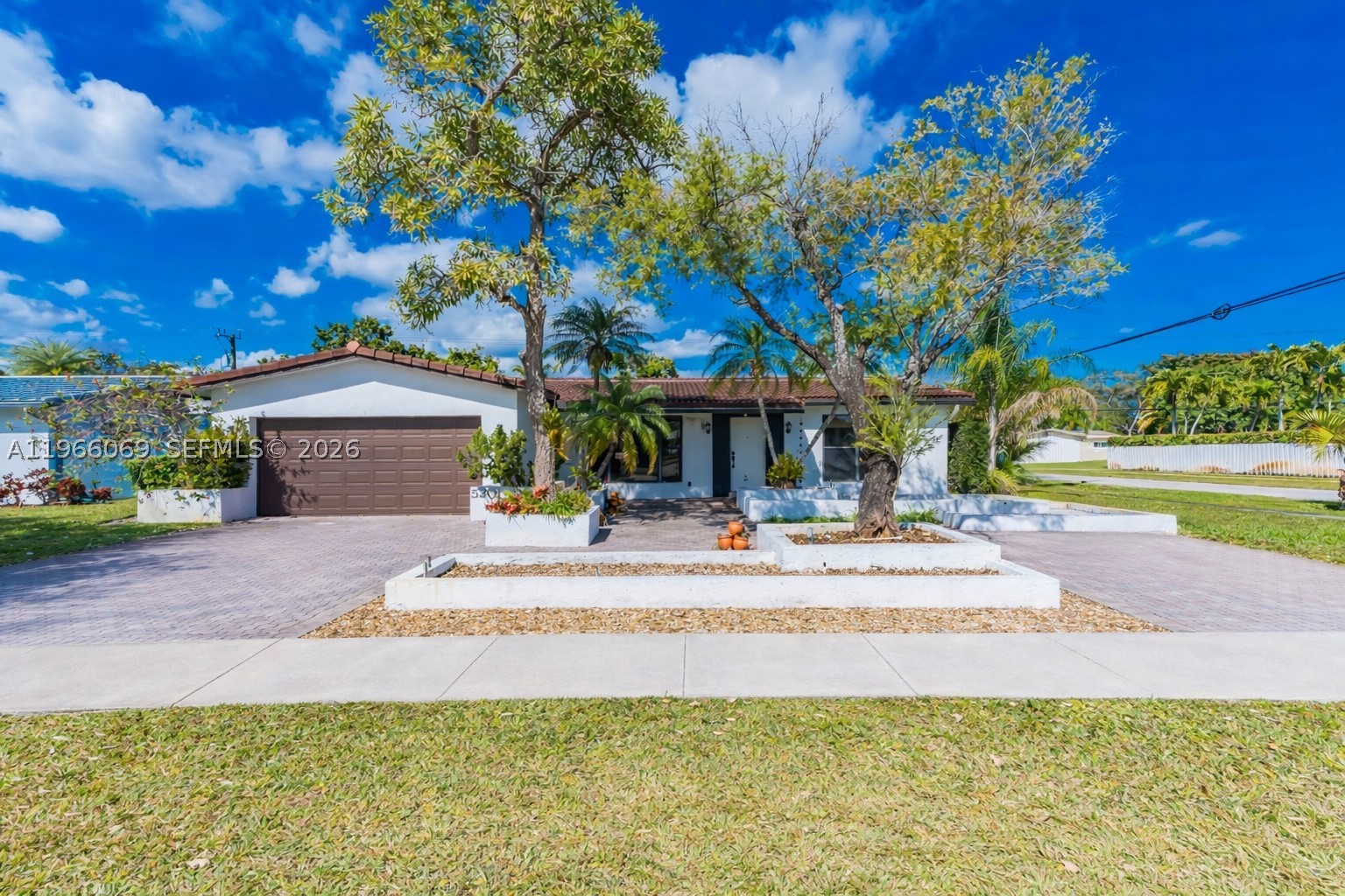 COMPLETE IMPACT WINDOWS AND DOORS, Newer Barrel Tile Roof (2019), Newer A/C (2021) RARE CORNER LOT!! Beautiful 3-bedroom, 2-bath home situated on an OVERSIZED, fully fenced in corner lot with a heated pool in a prime location. This property features New tile flooring, 2-car garage, 2-car driveway, and a rare additional concrete slab along the rear side of the property with easy side-gate access, a true boater and RV enthusiast’s dream! Perfect for storing boats, RVs, or trailers with convenient in-and-out access, plus the potential for additional parking income. The thoughtfully designed layout offers spacious living and dining areas and a large kitchen with eat-in space. The  backyard feels like a private retreat, complete with a covered patio that opens to the pool and generous yard space. The expansive primary suite includes a large walk-in closet and a spa-style bathroom with dual sinks, separate shower, and whirpool tub. Ideally located next to a park, less than 10 minutes to the beach, and close to major highways, major airports, shopping, and dining - a one of a kind property in the heart of Hollywood!