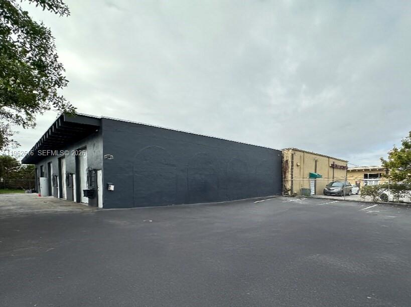 Two adjacent industrial warehouse buildings totaling approximately 12,000 SF are offered for sale in West Hollywood / West Park, Florida, just east of US 441 / State Road 7 with convenient access to Florida’s Turnpike and Interstate I-95. The offering includes 5812, a 6,000 SF warehouse leased month-to-month allowing immediate owner-user occupancy, and 5818, a 6,000 SF multi-bay warehouse with five 1,200 SF bays and staggered lease expirations providing in-place income. Both properties feature 18’–20’ clear ceiling heights, are fully fenced, and are approved for auto mechanic use.