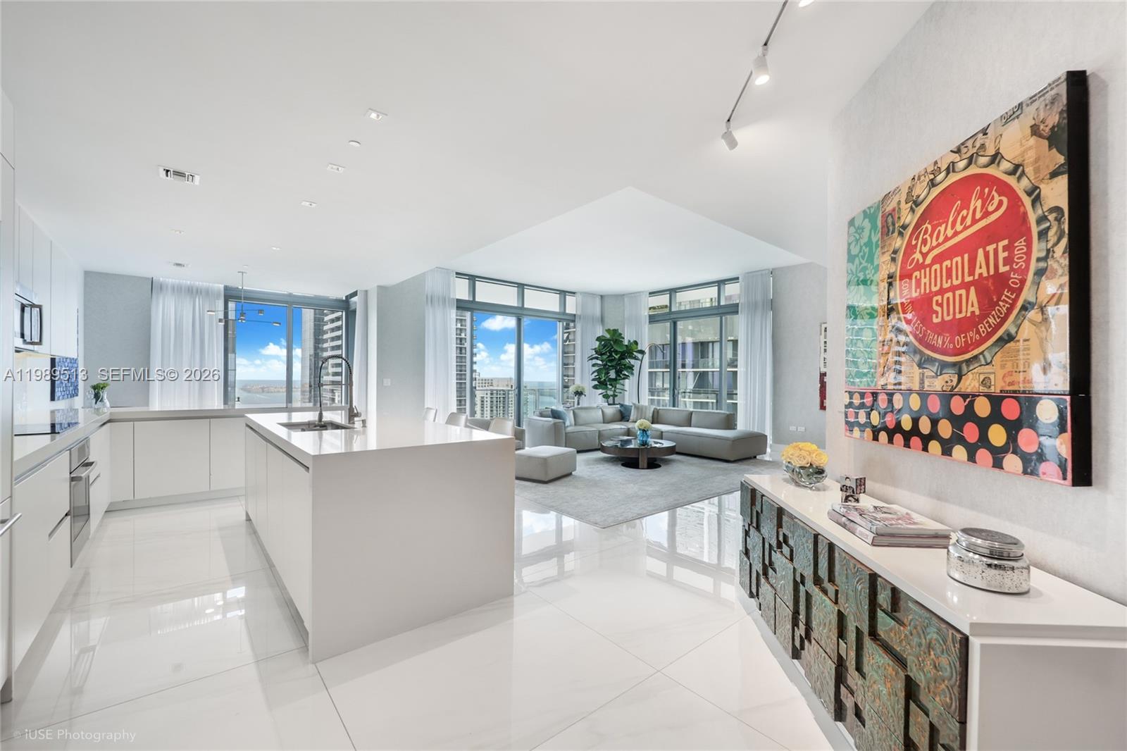 Stunning 4BR/4.5BA lower penthouse at Rise, Brickell City Centre. Featuring 12 ft ceilings, 48"x48" Italian porcelain floors, custom Italian cabinetry, quartz waterfall island, floating vanities, and electric shades. Spacious walk-in closets in all bedrooms, large laundry room, and maid’s room with bath. Enjoy panoramic sunrise-to-sunset water and skyline views from 9-ft deep wraparound balconies. Includes 2 parking spaces and complimentary valet for guests.