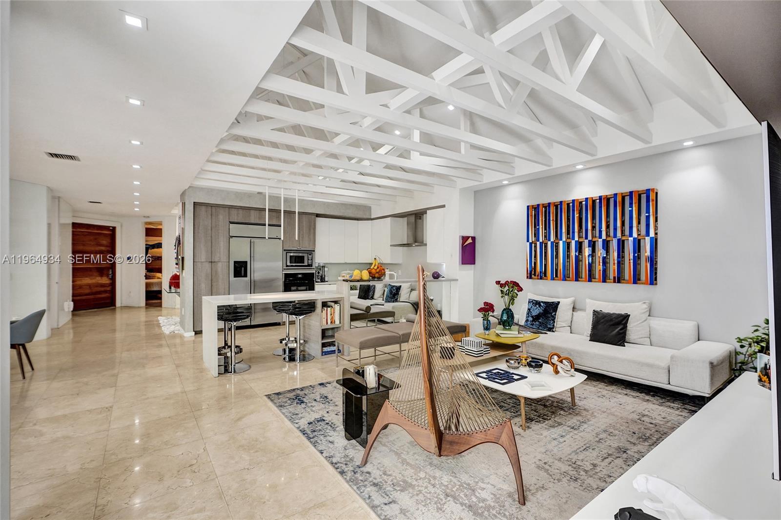 Welcome to one of the most architecturally striking homes in Presidential Estates. Featuring soaring ceilings with exposed beams, expansive open living spaces, and a fully updated kitchen with high-end stainless steel appliances and an oversized island designed for entertaining.
The indoor-outdoor flow leads to a private backyard with a wood deck, pool, and jacuzzi, creating the perfect South Florida lifestyle setting.
Designer bathrooms, custom finishes,s and abundant natural light throughout.
Move-in ready and arguably the best modern option currently available in Presidential.

Without question, one of the best modern options in the neighborhood.
