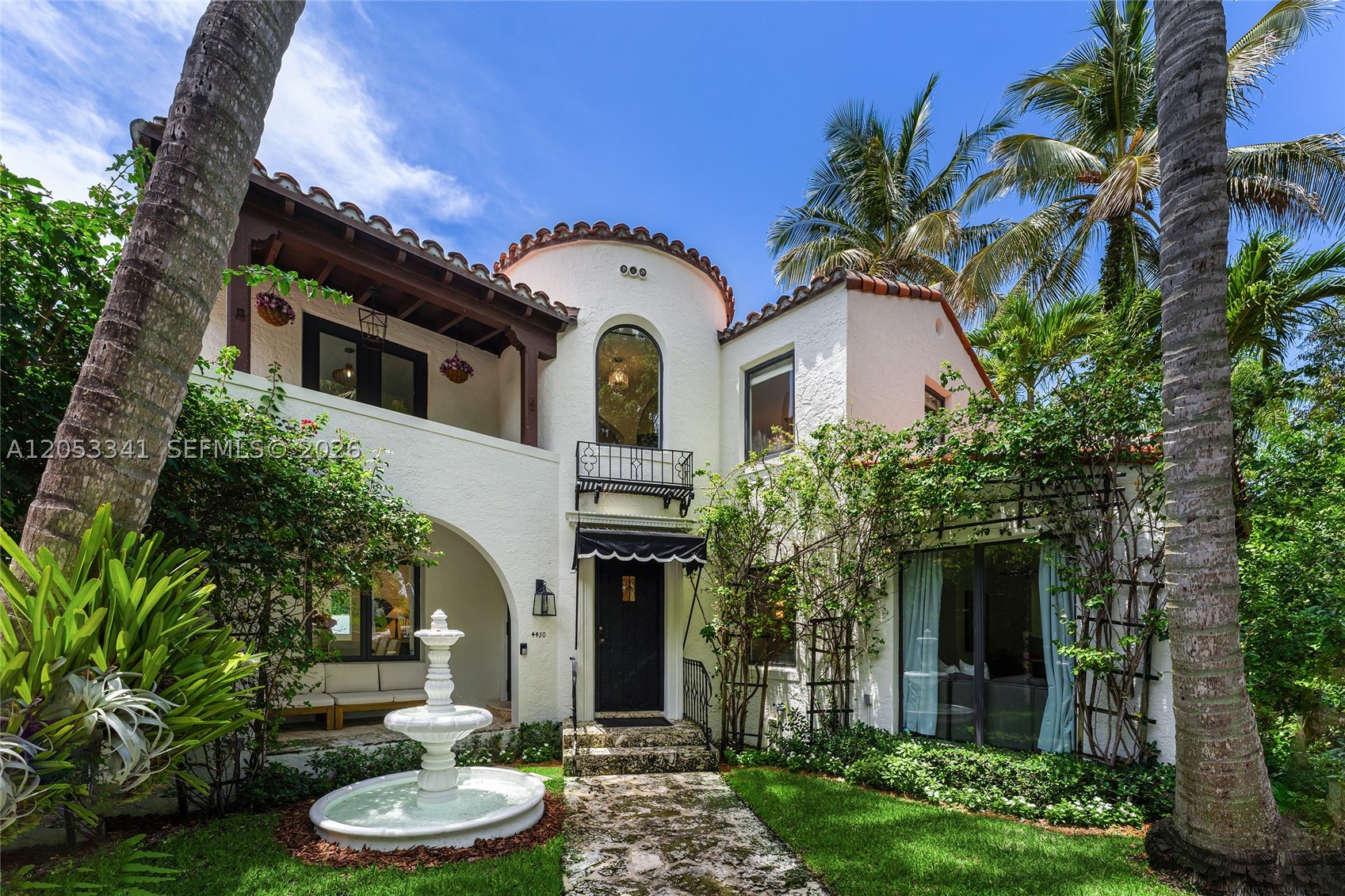 This beautifully remodeled two-story Mediterranean-style home in the heart of Miami Beach offering 5BR/5.5BA blends classic Mediterranean character with luxury designer updates and modern amenities throughout. A security-gated entrance, circular coral stone driveway, beautiful fountain, lush tropical landscaping, and covered carport create exceptional curb appeal and a welcoming first impression. Inside, the home features original quarry tile floors, rich hardwood floors, wood-beamed ceilings, two wood-burning fireplaces, formal living and dining rooms, plus a flexible sunroom/den filled with natural light. The chef’s kitchen offers a La Cornue range with double ovens and hood, Sub-Zero refrigerator/freezer, Shaw’s Original fireclay sink, marble countertops, water purification system, and a light-filled breakfast room overlooking the pool. The principal suite includes a private covered balcony, walk-in closet, spacious dressing room with dual closet areas, and a beautiful bath with subway tiles, solid copper soaking tub and dual-head glass shower. 3 additional bedrooms in the home offer ensuite bathrooms. New electric & plumbing as of 2023. Outdoor spaces made for relaxing/entertaining, with a heated saltwater pool, fountain, coral stone deck, outdoor shower, multiple lounge areas, privacy hedge, alfresco dining area, and a separate private guest house with full bath. Ideally located minutes from beaches, fine dining, shopping, parks, galleries, Downtown Miami, and MIA.