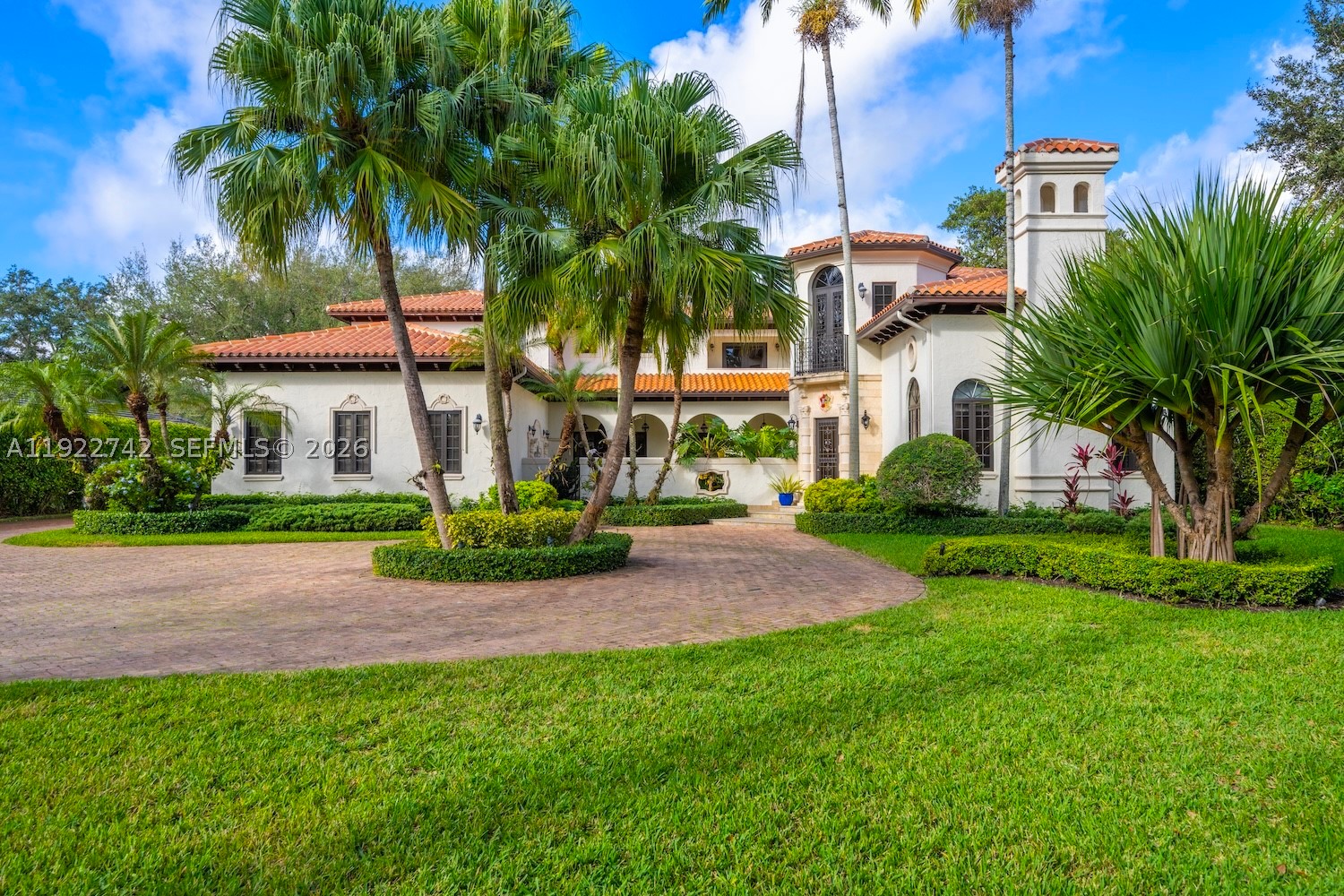 Tucked away on a lush builder’s acre in prestigious North Pinecrest, this exceptional Spanish-inspired estate seamlessly blends timeless architecture with sophisticated contemporary updates. Offering unparalleled privacy and resort-style living, the property features seven bedrooms, including a spacious detached guest house ideal for extended family, guests, or a private office. The spectacular grounds are designed for both relaxation and recreation, showcasing a sparkling pool, a newly completed pickleball court, expansive covered terraces, and beautifully landscaped gardens. Entertain effortlessly with a summer kitchen, a pizza oven and gracious indoor-outdoor living spaces that capture the essence of South Florida living. Inside, soaring vaulted ceilings and a dramatic fireplace graces the elegant formal living room, while the formal dining room, updated chef’s kitchen with breakfast area, and expansive family room provide exceptional spaces for everyday living and entertaining. 
The luxurious primary suite serves as a private retreat, complete with a spa-inspired bathroom. Additional highlights include a three-car garage with lift, abundant parking, and a gated setting in one of Pinecrest’s most desirable neighborhoods. A rare opportunity to own a private resort-style sanctuary where luxury, comfort, and lifestyle come together.