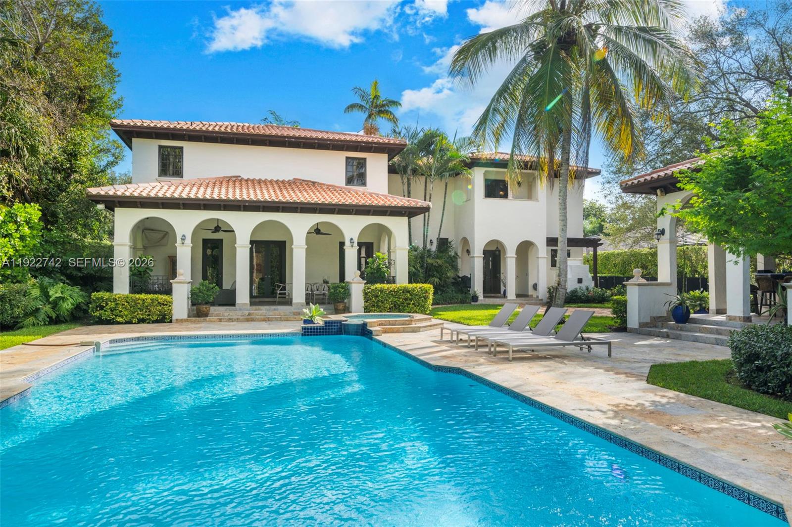 Set back quietly on a verdant builder’s acre in exclusive North Pinecrest, this beautiful Spanish style home with a contemporary update offers an exceptional blend of space, privacy, & resort-style living. This expansive estate features 7 BRs, including a generous guest house ideal for extended family or guests. Lush grounds showcase a sparkling pool, jacuzzi, new pickleball court, & multiple covered living areas for effortless entertaining. Enjoy a well-appointed summer kitchen w/ pizza oven, seamless indoor-outdoor flow, & 3-car garage w/lift. Inside find a formal living room w/ vaulted ceiling & fireplace, dining room, updated chef’s kitchen w/ dinette, family room, & fabulous primary suite w/ spa-like bath. This is a rare opportunity to own a resort-like retreat in the best location!