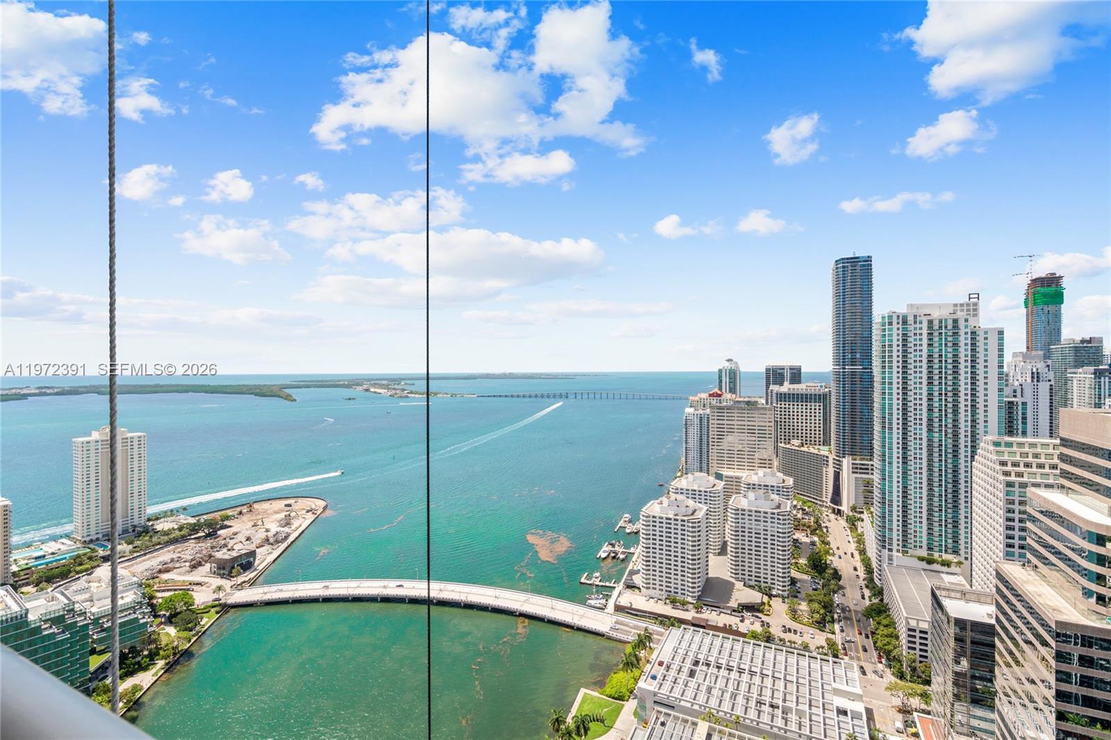 Iconic Arquitectonica building with interiors by Philippe Starck. Best line with views of Brickell Key, Biscayne Bay & skyline. Split 2/2 + Den. High-end appliances. Amenities: pool, spa, fitness, concierge. Short walk to Brickell City Centre. Basic cable/internet + 1 parking included. Unfurnished. Pet-friendly. Exterior renovations ongoing; balcony reopening expected soon per HOA. 1,450 sq ft living / 1,655 sq ft total. Non-original A/C, floors & washer/dryer. VACANT. Open to offers. Motivated seller.