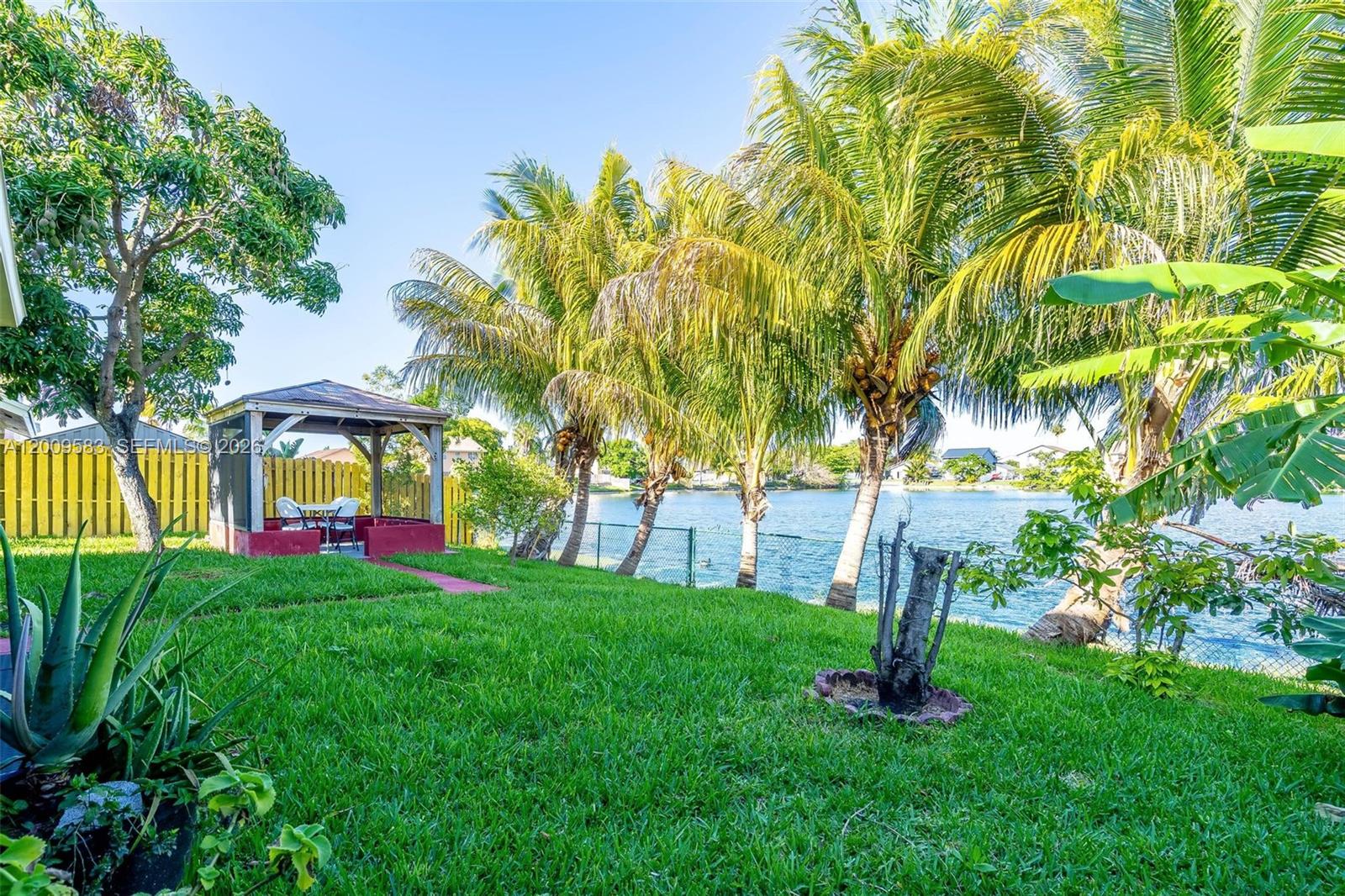 Motivated Seller! This Partially Furnished Waterfront Home offers a Whole-House Water Purification System, 2025 central A/C, and a 2019 Roof, with Recently Updated Major Appliances. Experience true South Florida living with Coconut, Mango, and Avocado Trees in your Private Backyard. The Spacious Primary Suite includes a Flexible Room ideal for a Den or Home Office. Conveniently Located in a tranquil Neighborhood, near Shopping, Hospitals, and Major Highways.