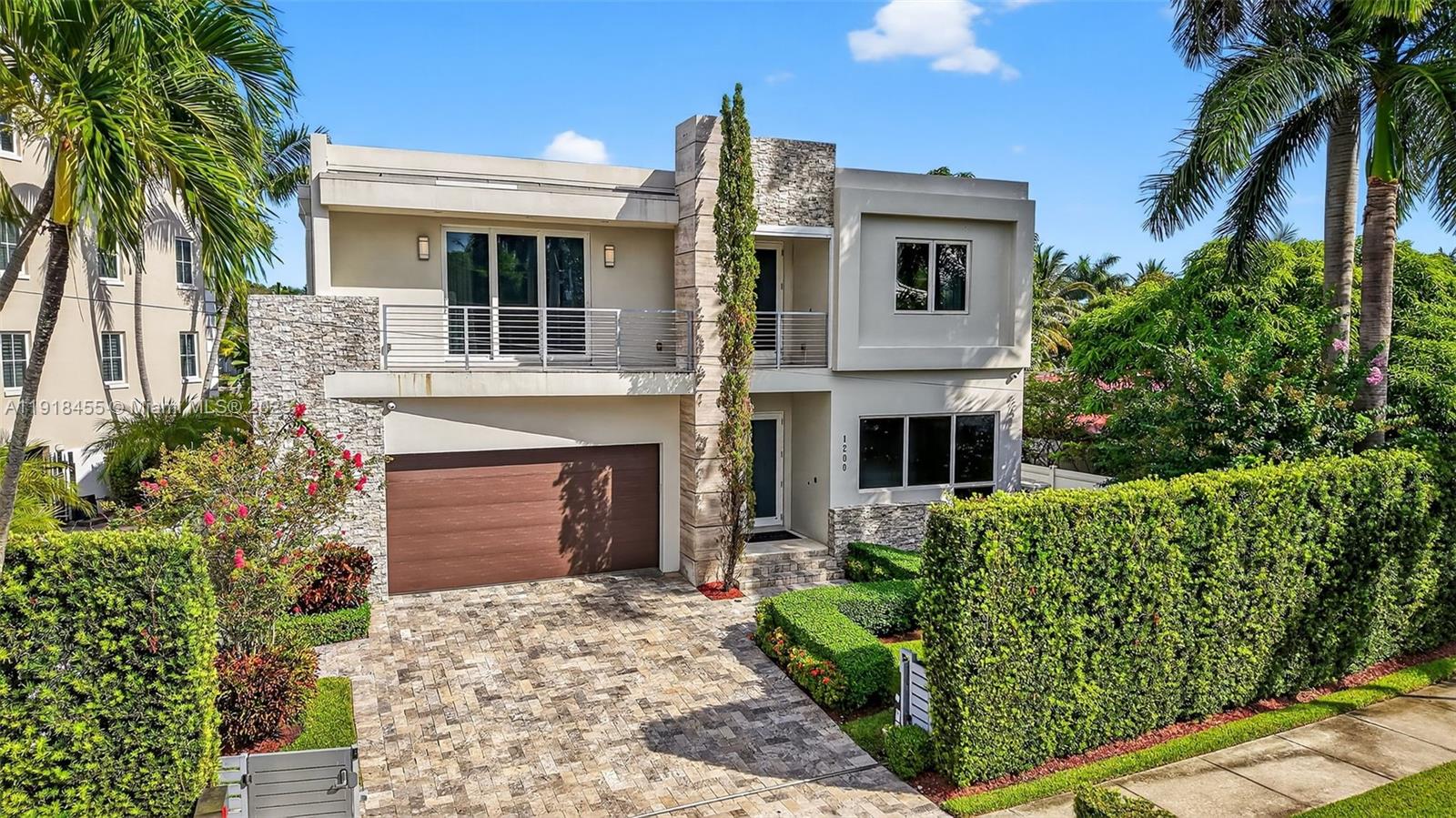 This stunning two-story waterfront home combines elegance and tranquility, features 4 bedrooms and 4 1/2 bathrooms, open den/office or library with large balcony. Over the top master suite, spacious walk-in closets, large balcony overlooking the bay, his/her bathroom, double showers and sauna. Eac room has been designed by interior decorator with custom wallpaper, white porcelain floors give the home a clean elegant touch. Gourmet kitchen by Mia Cucina, Wolf gas stove, large pantry, and wine cellar. Breakfast area with breathtaking view of the bay. Elegant window treatment with motorized shades. The outdoor features built-in barbecue grill, large sink, heated pool and 40-foot boat dock. Property is secured by electronic gates, large driveway and two-car garage.